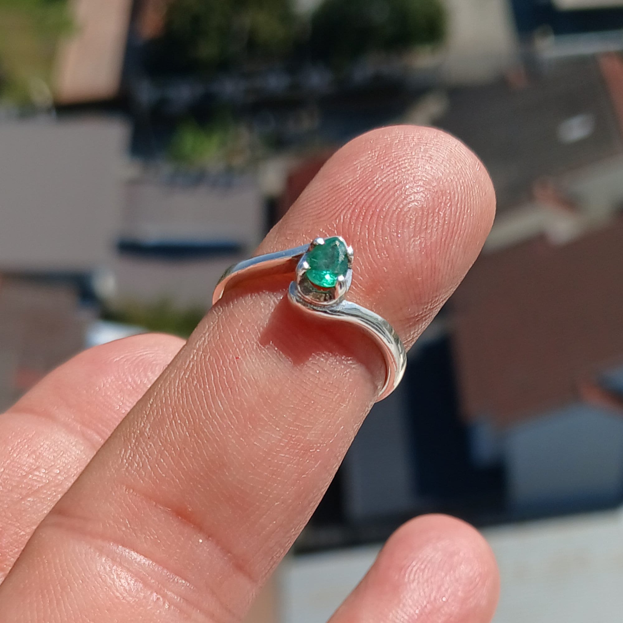 Handmade Sterling Silver Emerald Ring featuring a natural green Pear Shaped Emerald, showcasing its elegant design and craftsmanship.