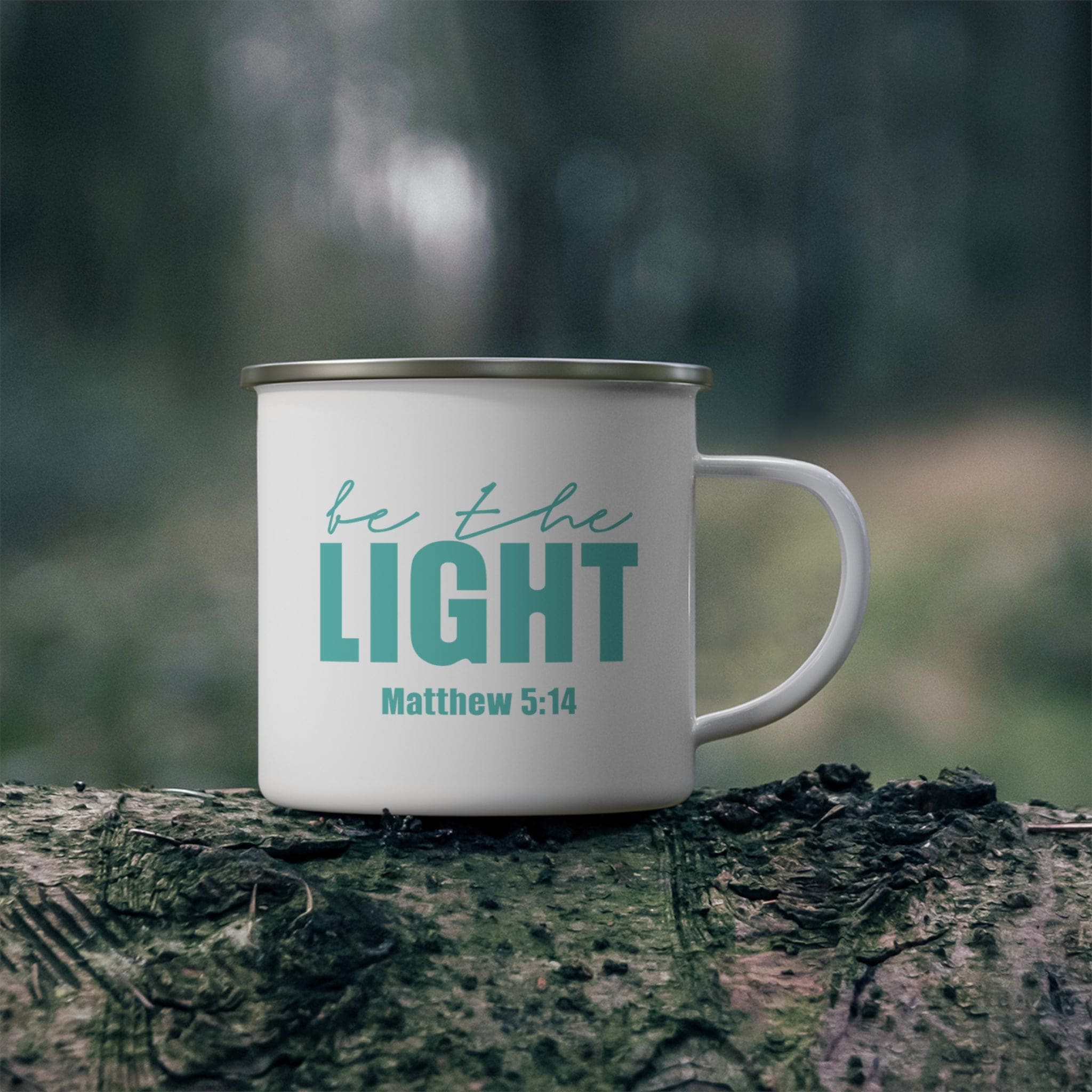 Durable enamel camping mug featuring a 'Be the Light' print, perfect for outdoor adventures and stylish drinkware.