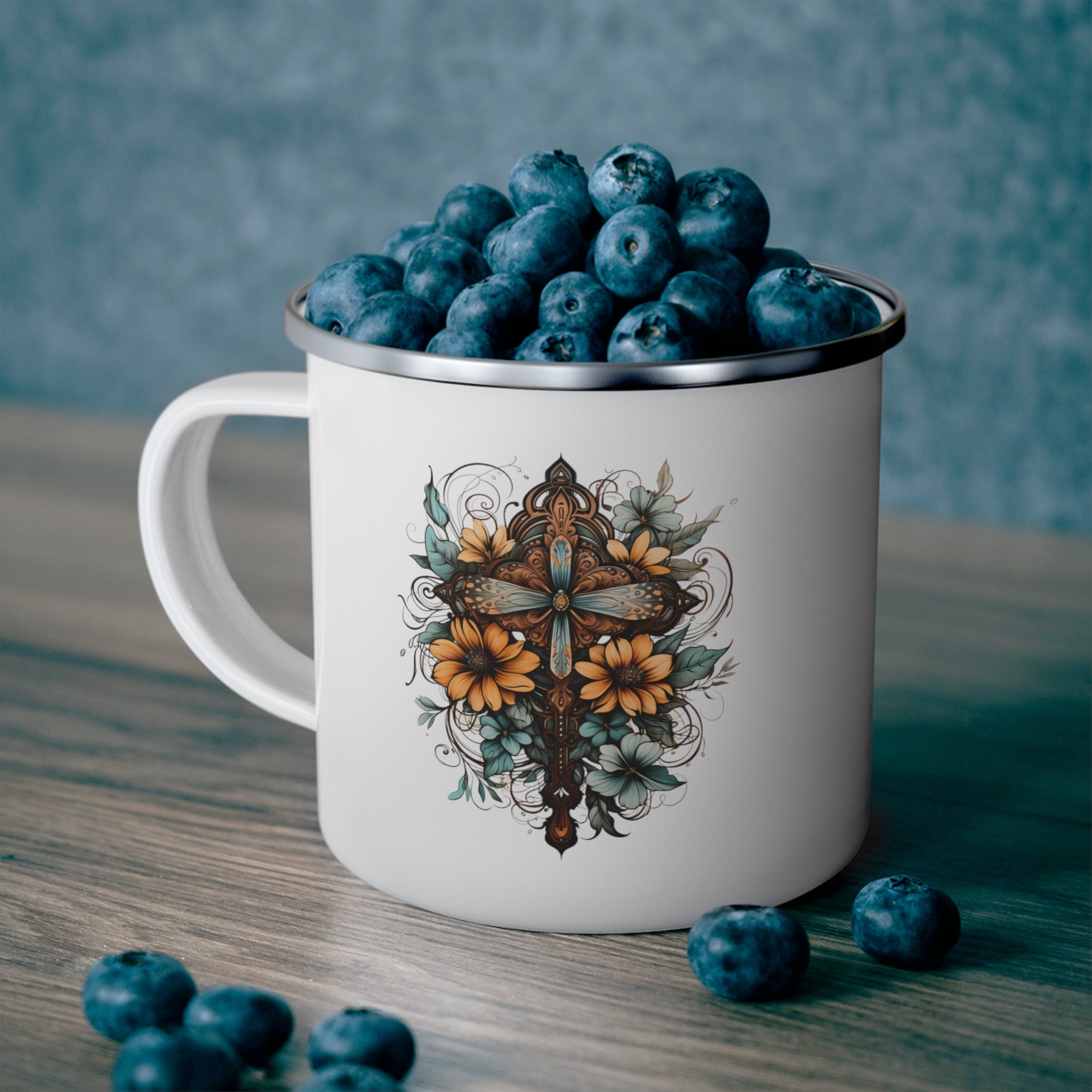 Blue, brown, and yellow enamel camping mug featuring a Christian cross floral bouquet design, perfect for outdoor and indoor use.