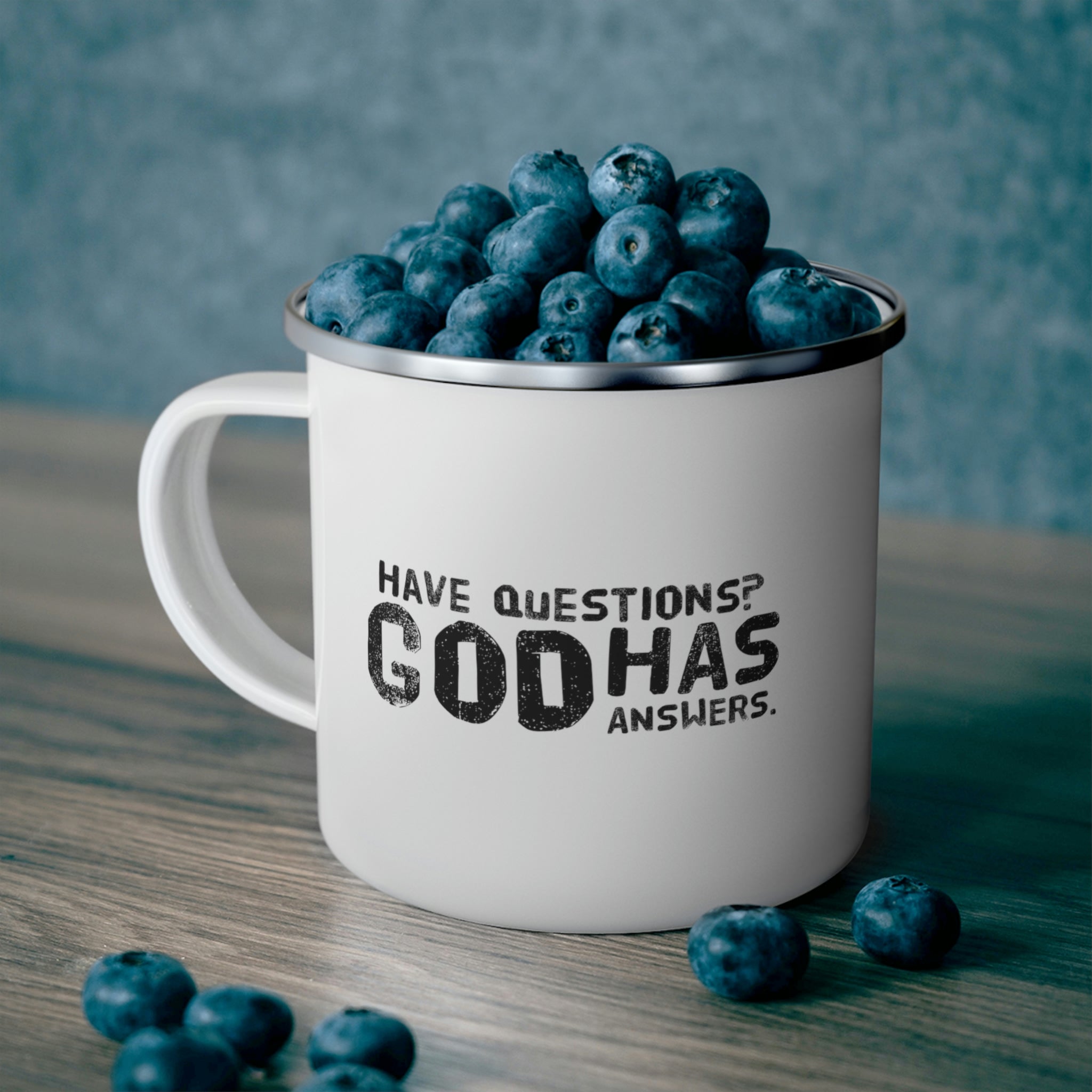 Durable enamel camping mug featuring a black illustration with the text 'Questions God has Answers', perfect for outdoor and indoor use.