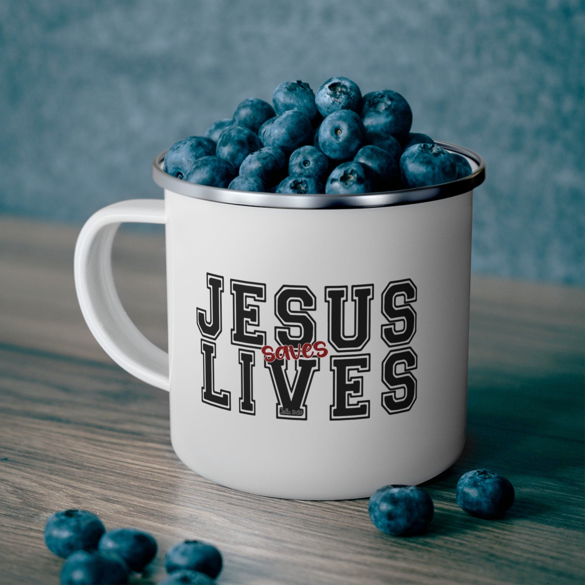 Durable enamel camping mug featuring a bold black and red 'Jesus Saves Lives' illustration, perfect for outdoor adventures.