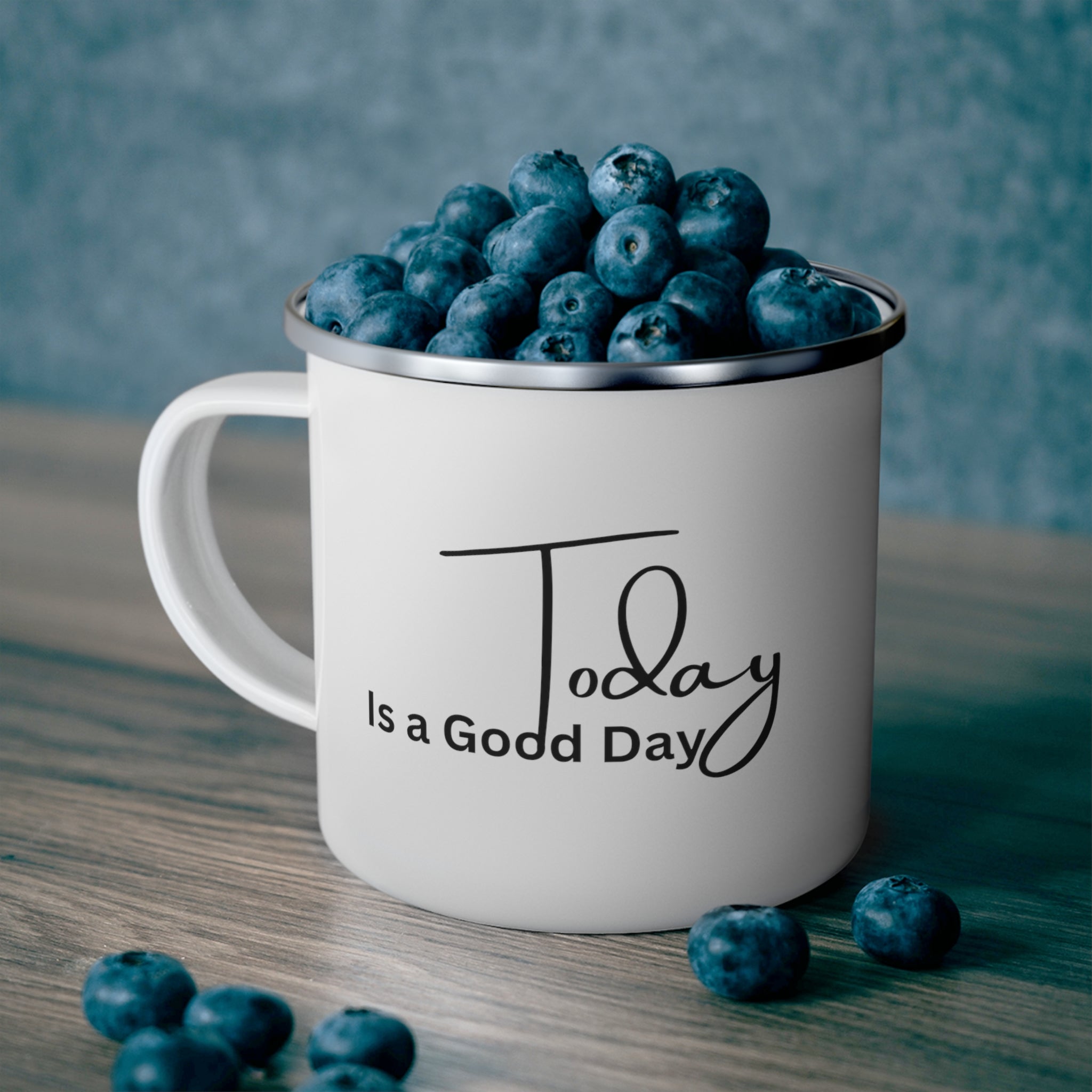 Durable enamel camping mug with a black illustration saying 'Today is a Good Day', perfect for coffee and outdoor activities.