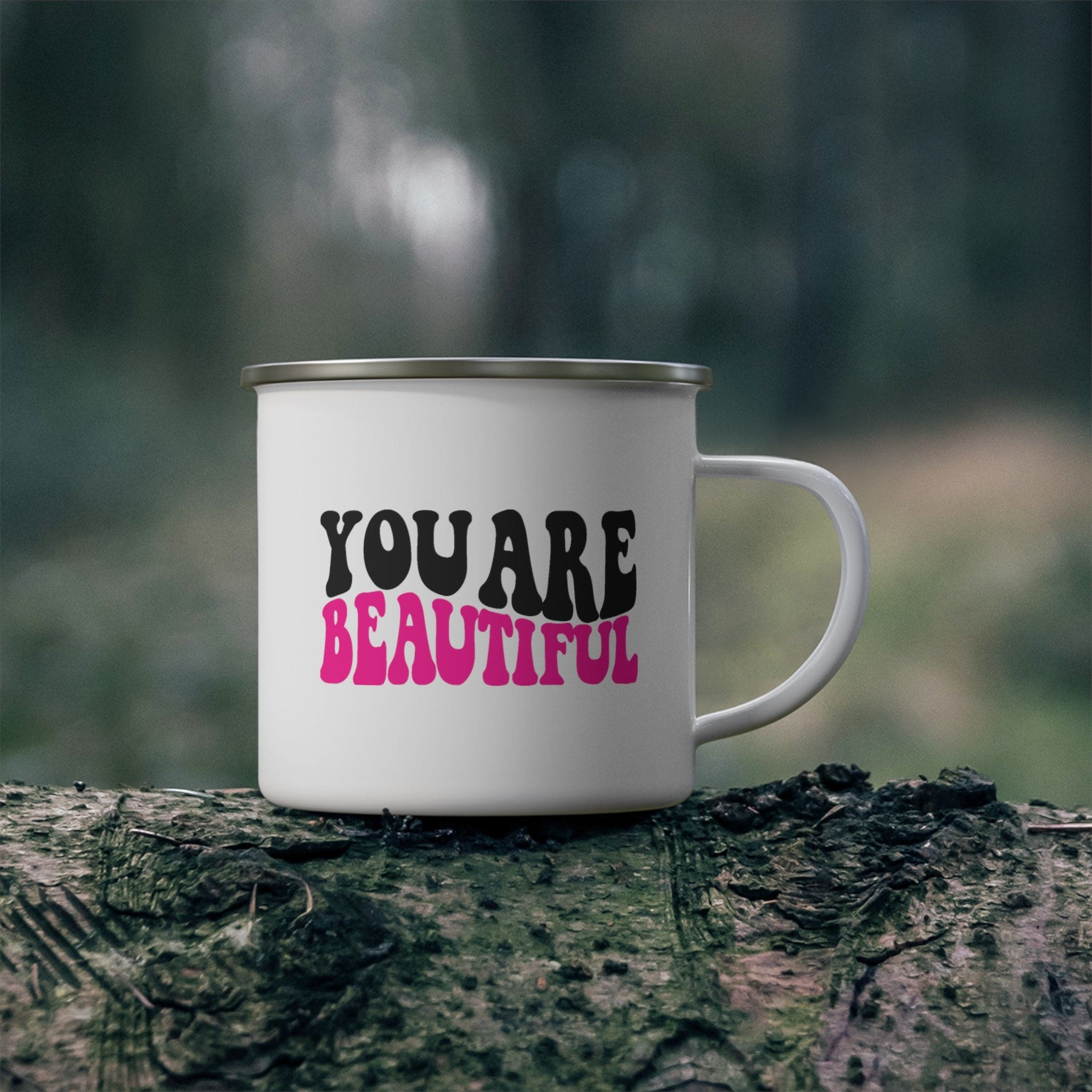 A stylish pink and black enamel camping mug with the affirmation 'you are beautiful' printed on it, perfect for outdoor and indoor use.