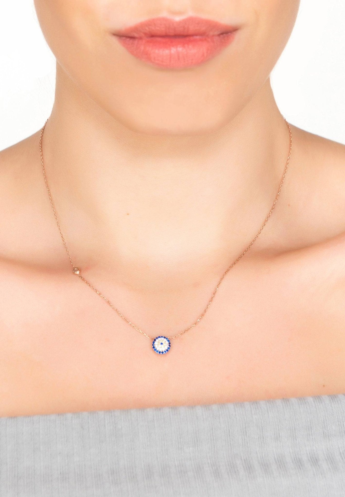 Evil Eye Necklace in rosegold featuring blue and white zircons, handcrafted from sterling silver.