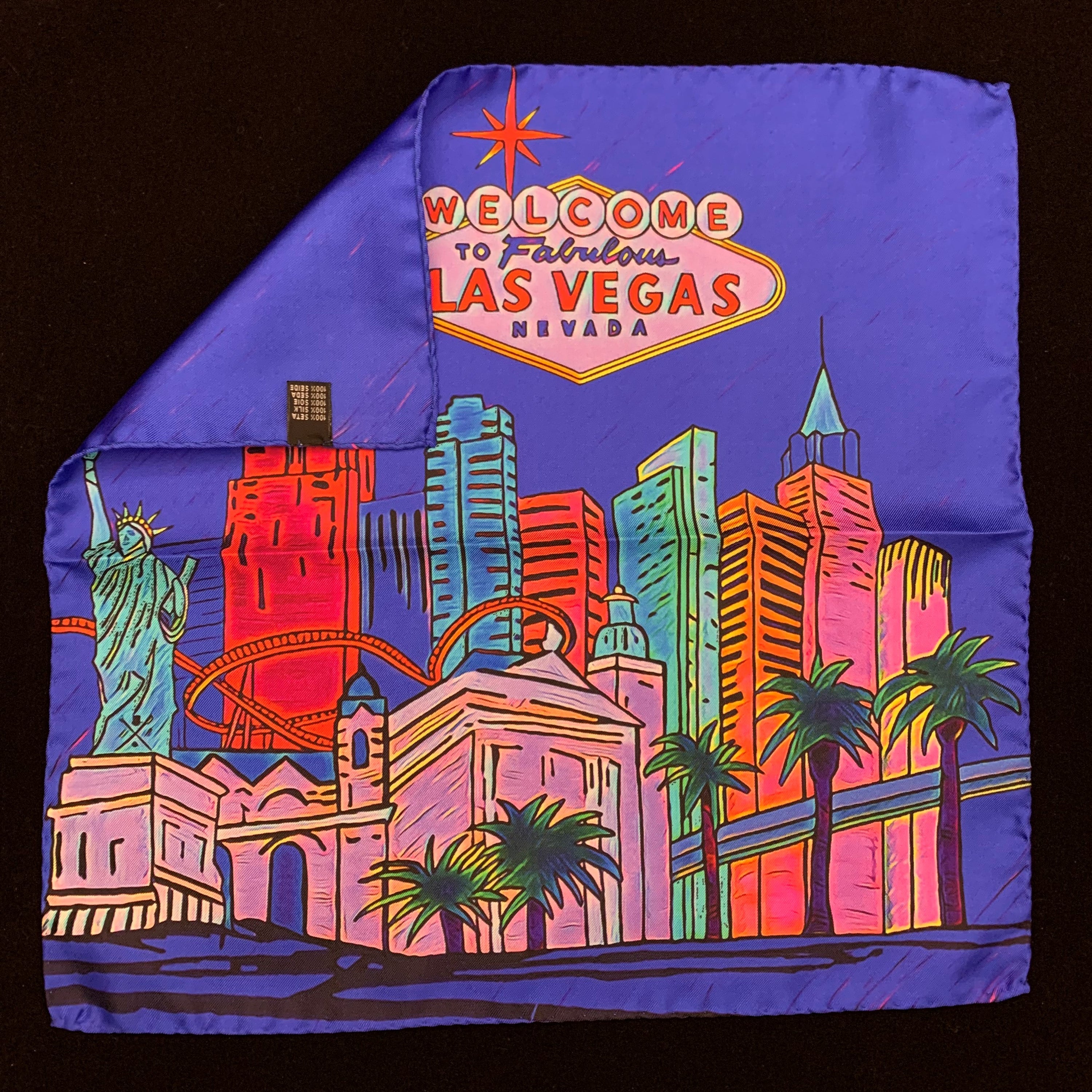 Fabulous Las Vegas Electric Blue Pocket Square featuring a hand-sketched design of the New York New York hotel in vibrant colors.