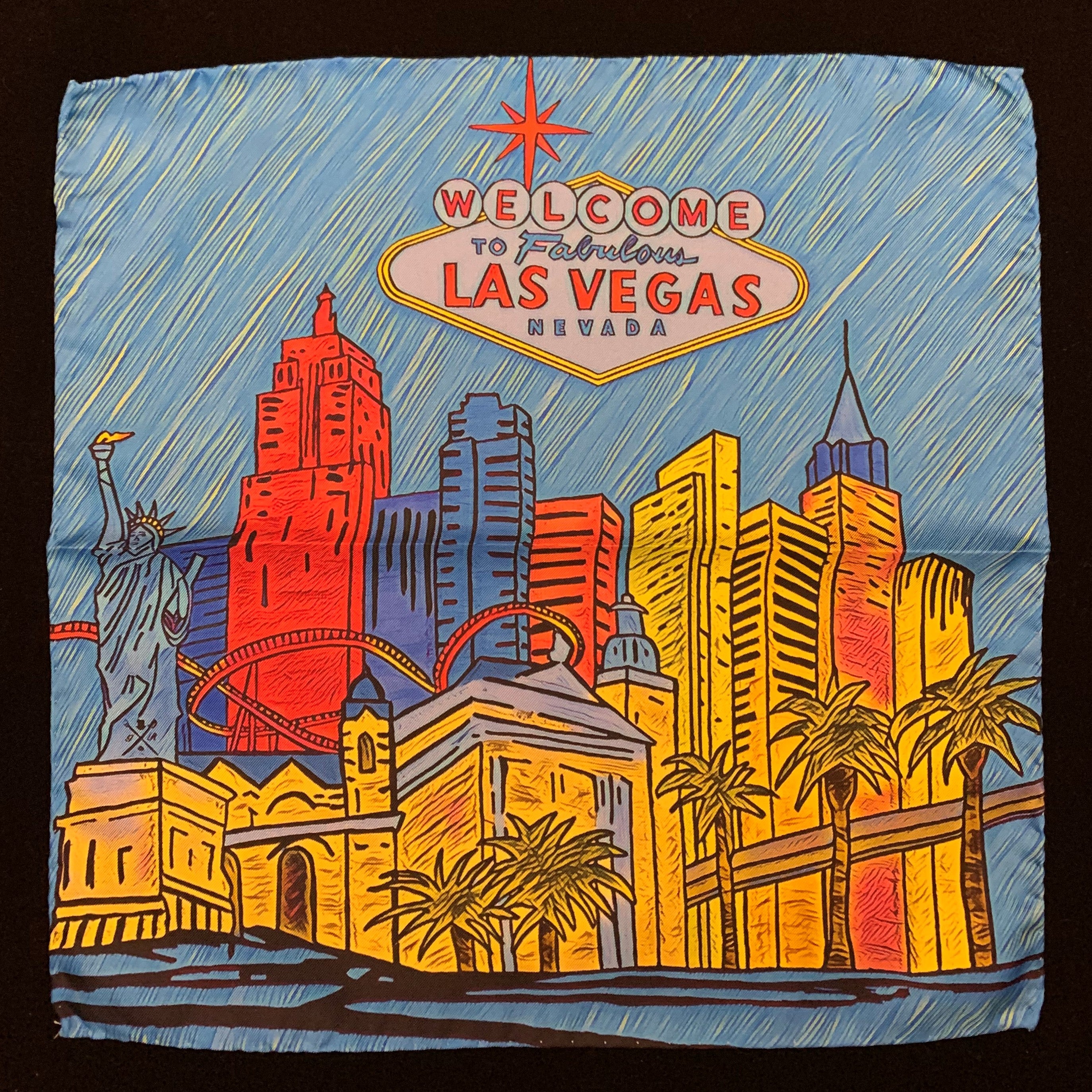 Fabulous Las Vegas Sky Blue Pocket Square featuring a hand-sketched design of the New York New York hotel in vibrant colors.