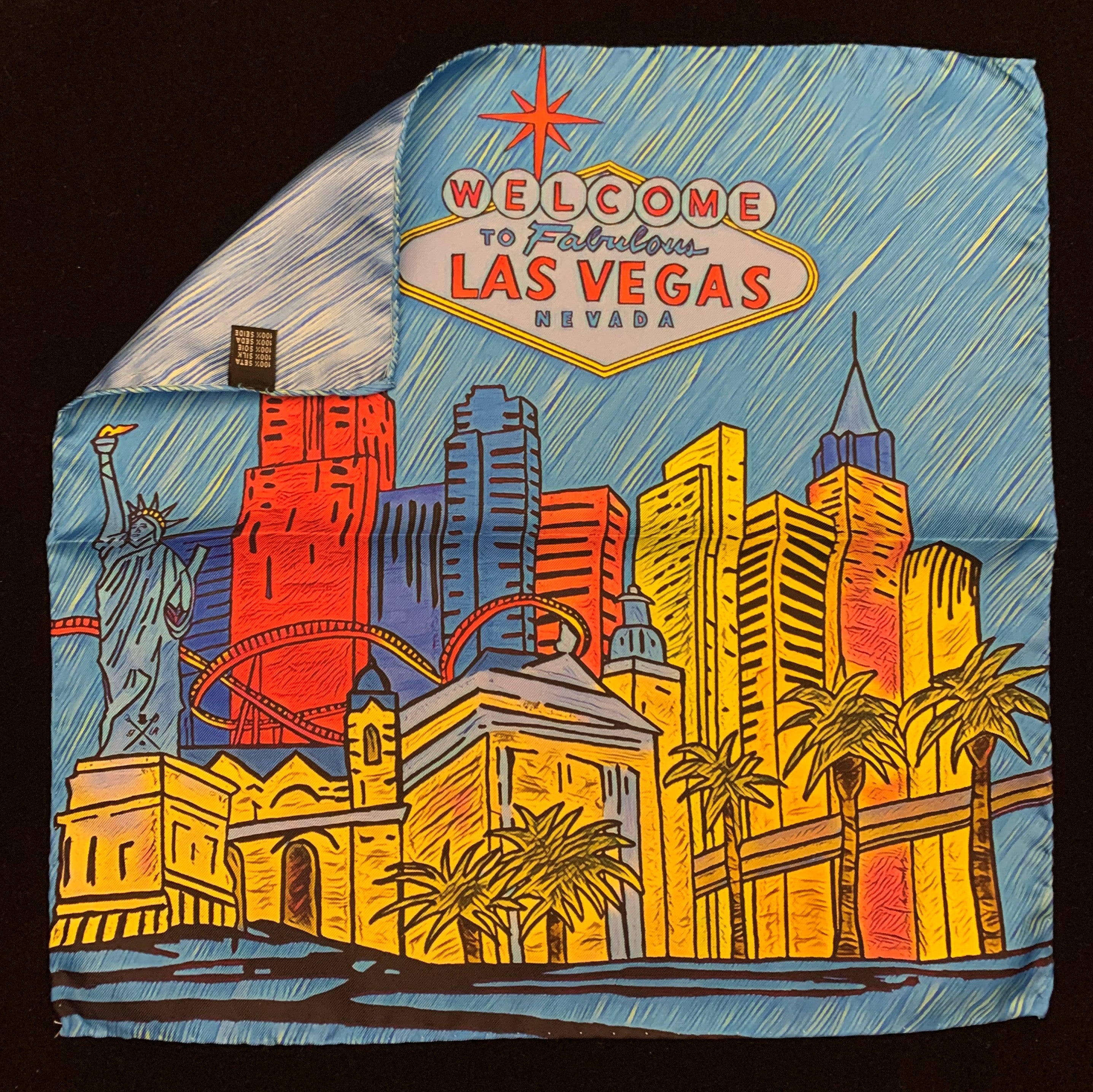 Fabulous Las Vegas Sky Blue Pocket Square featuring a hand-sketched design of the New York New York hotel in vibrant colors.