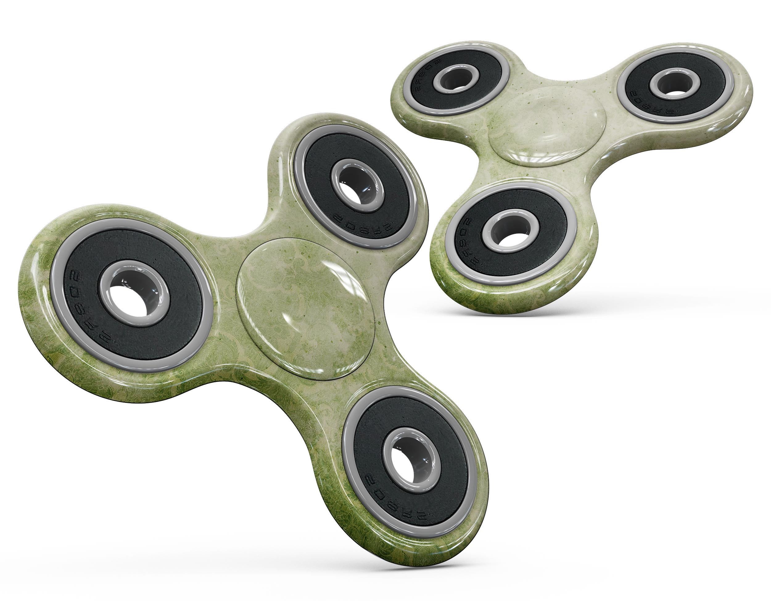 Faded green grunge damask pattern fidget spinner skin, showcasing its unique design and texture.