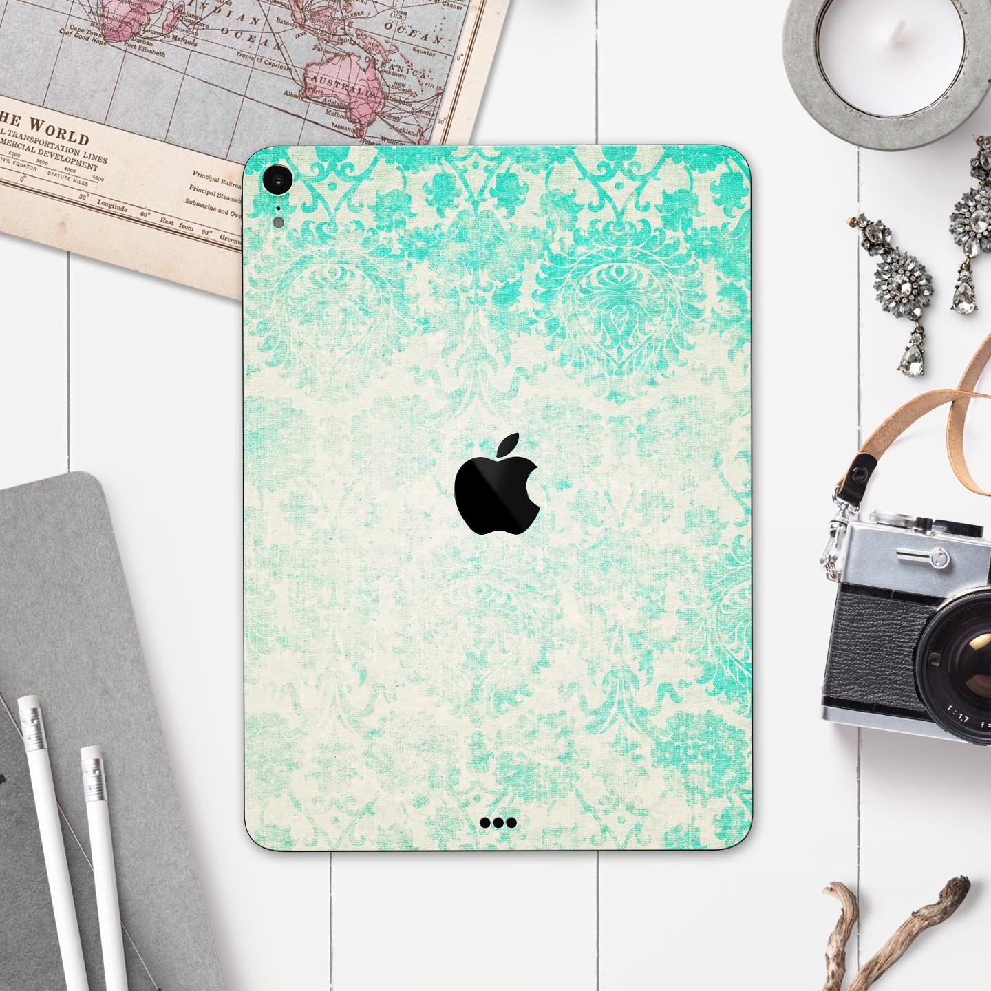 Faded teal pattern skin decal for Apple devices, showcasing intricate design and premium finish.