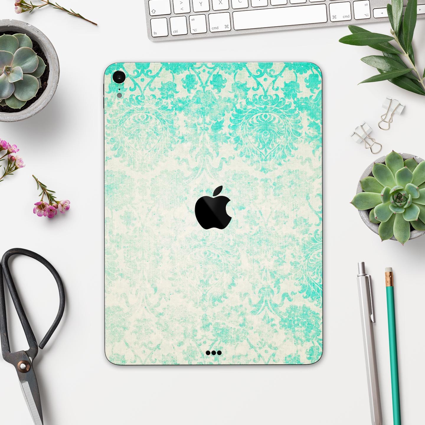 Faded teal pattern skin decal for Apple devices, showcasing intricate design and premium finish.