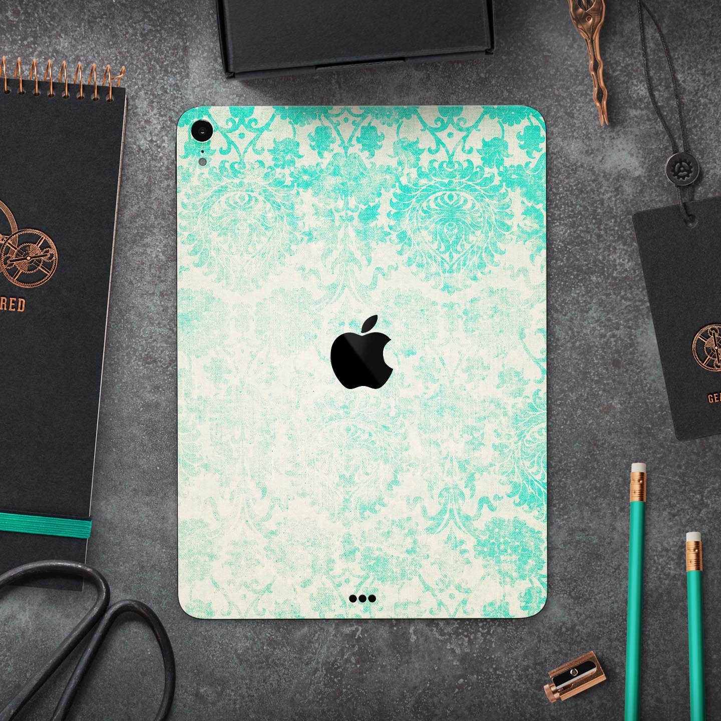 Faded teal pattern skin decal for Apple devices, showcasing intricate design and premium finish.