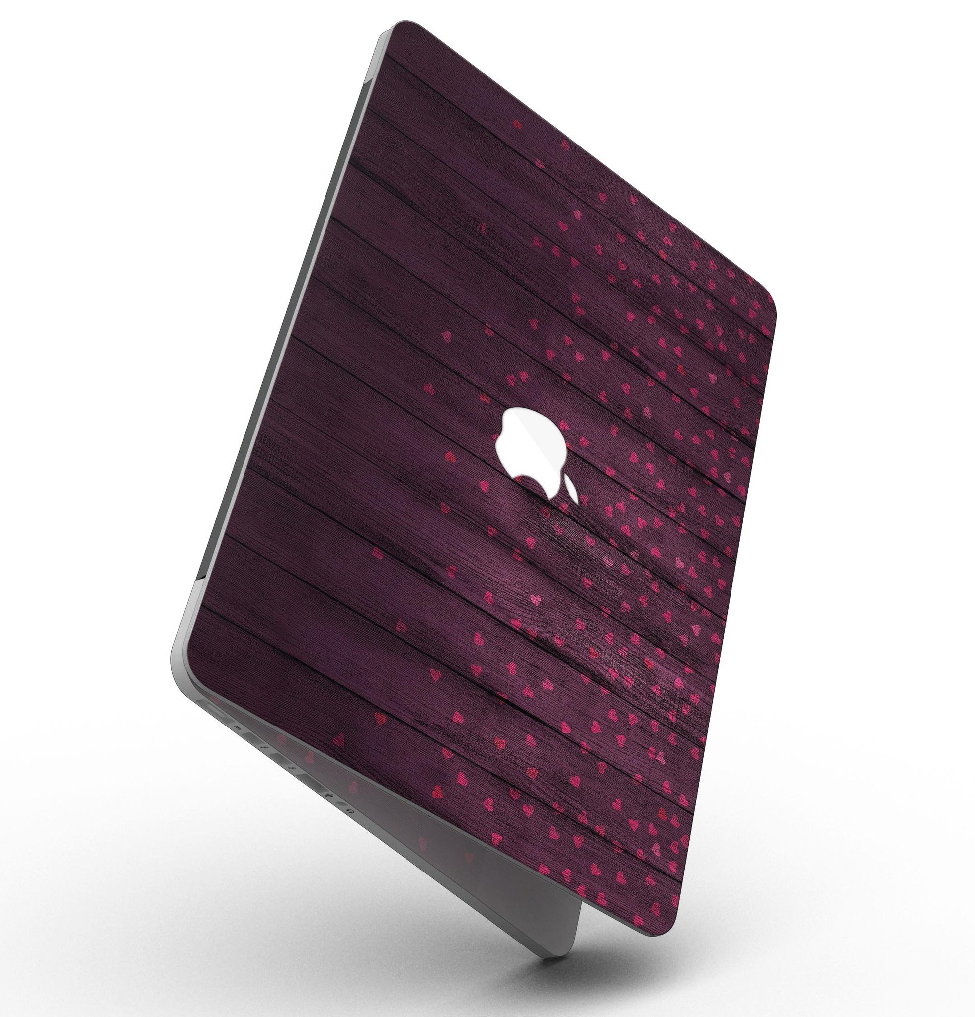 Falling Micro Hearts design skin for MacBook Pro, featuring a burgundy wood background and stylish heart patterns.