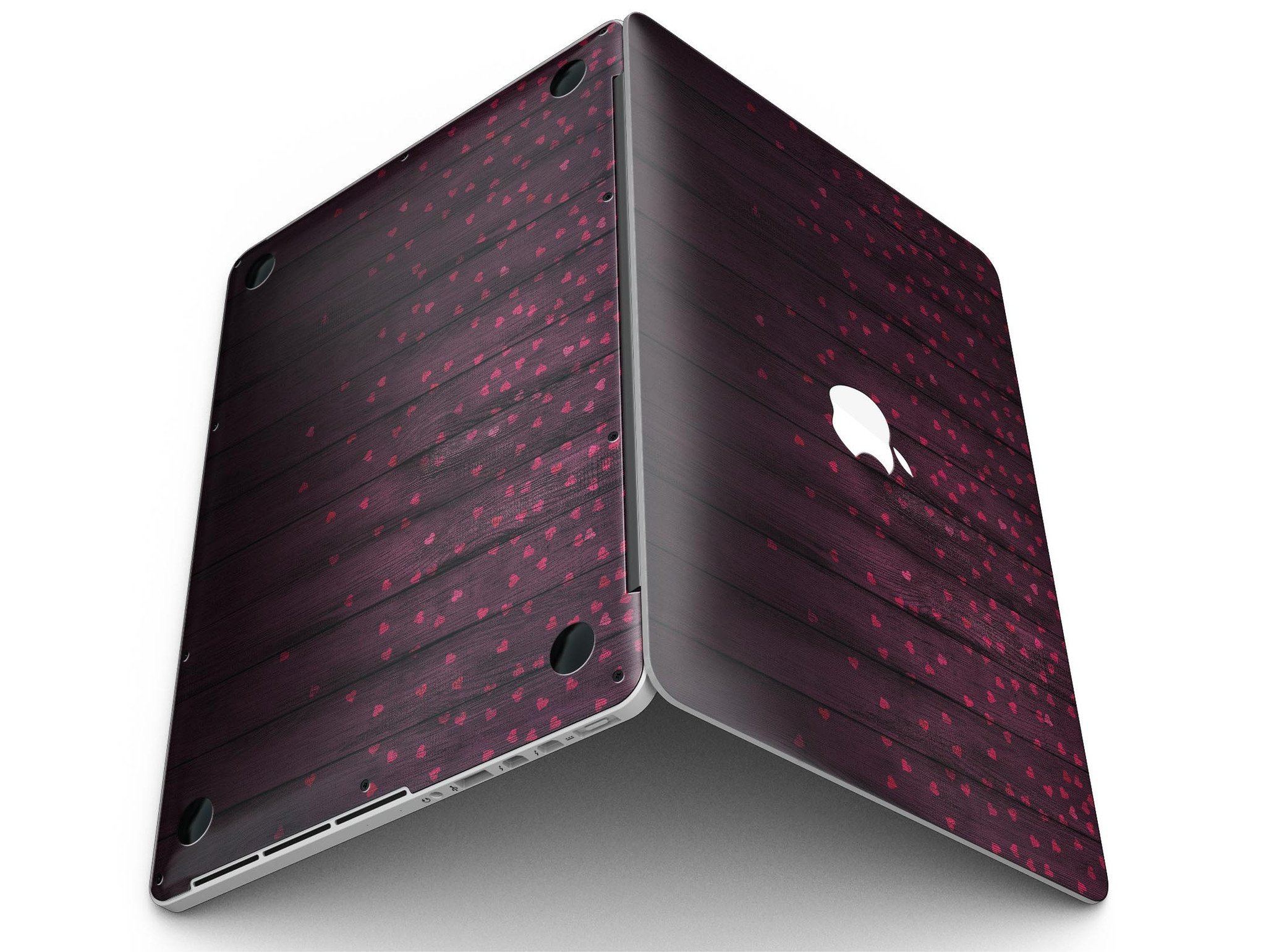 Falling Micro Hearts design skin for MacBook Pro, featuring a burgundy wood background and stylish heart patterns.