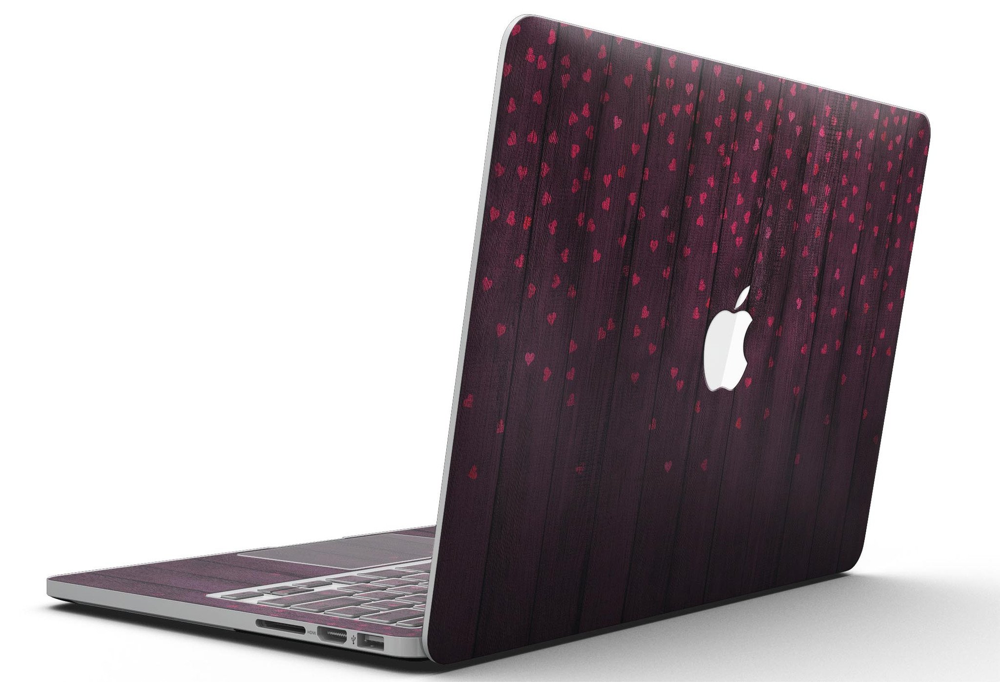 Falling Micro Hearts design skin for MacBook Pro, featuring a burgundy wood background and stylish heart patterns.