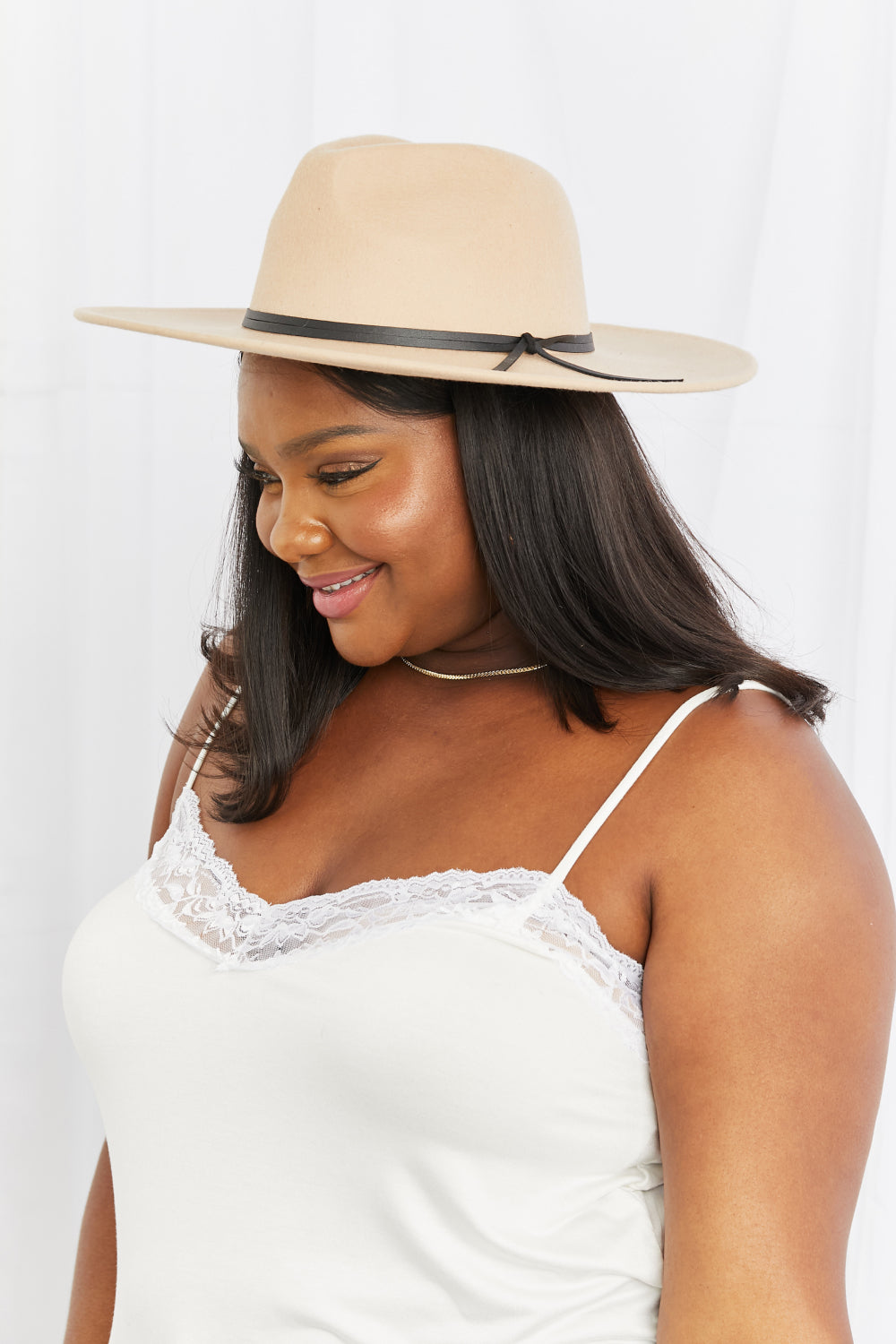 Fame Make It Work Fedora Hat in soft beige with black faux leather knot detailing, showcasing its elegant design and adjustable straps.