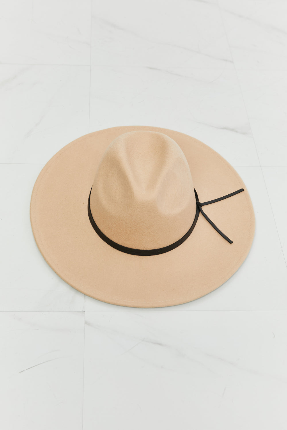 Fame Make It Work Fedora Hat in soft beige with black faux leather knot detailing, showcasing its elegant design and adjustable straps.