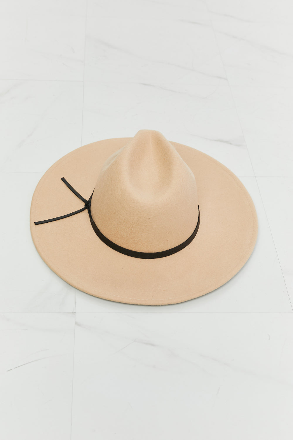 Fame Make It Work Fedora Hat in soft beige with black faux leather knot detailing, showcasing its elegant design and adjustable straps.