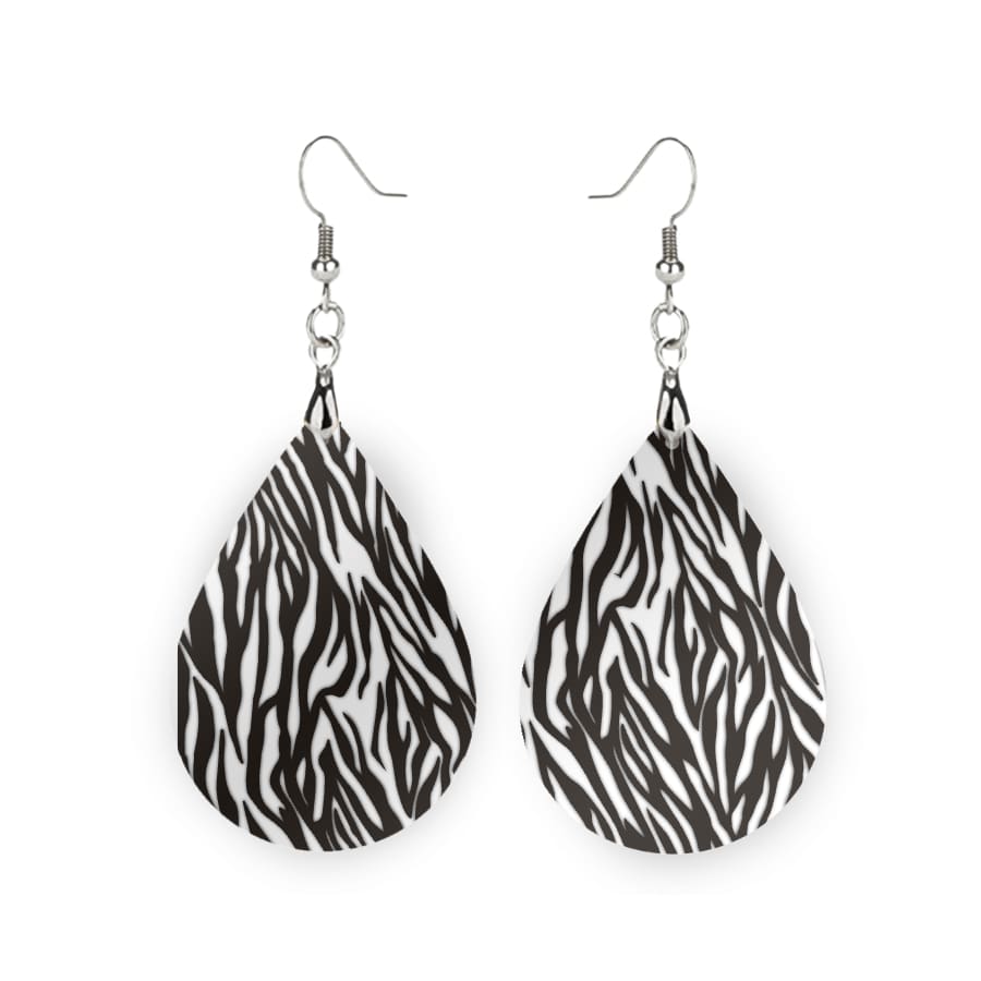 Stylish oval drop earrings with a black and white striped design, made from durable MDF wood.