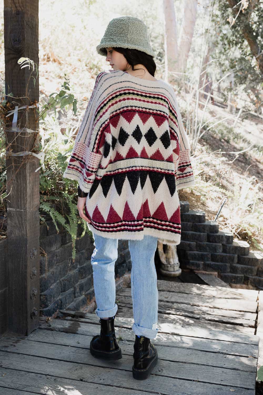 A stylish Faux Hair Aztec Pocket Ruana featuring a vibrant Aztec print and two functional pockets, perfect for winter wear.