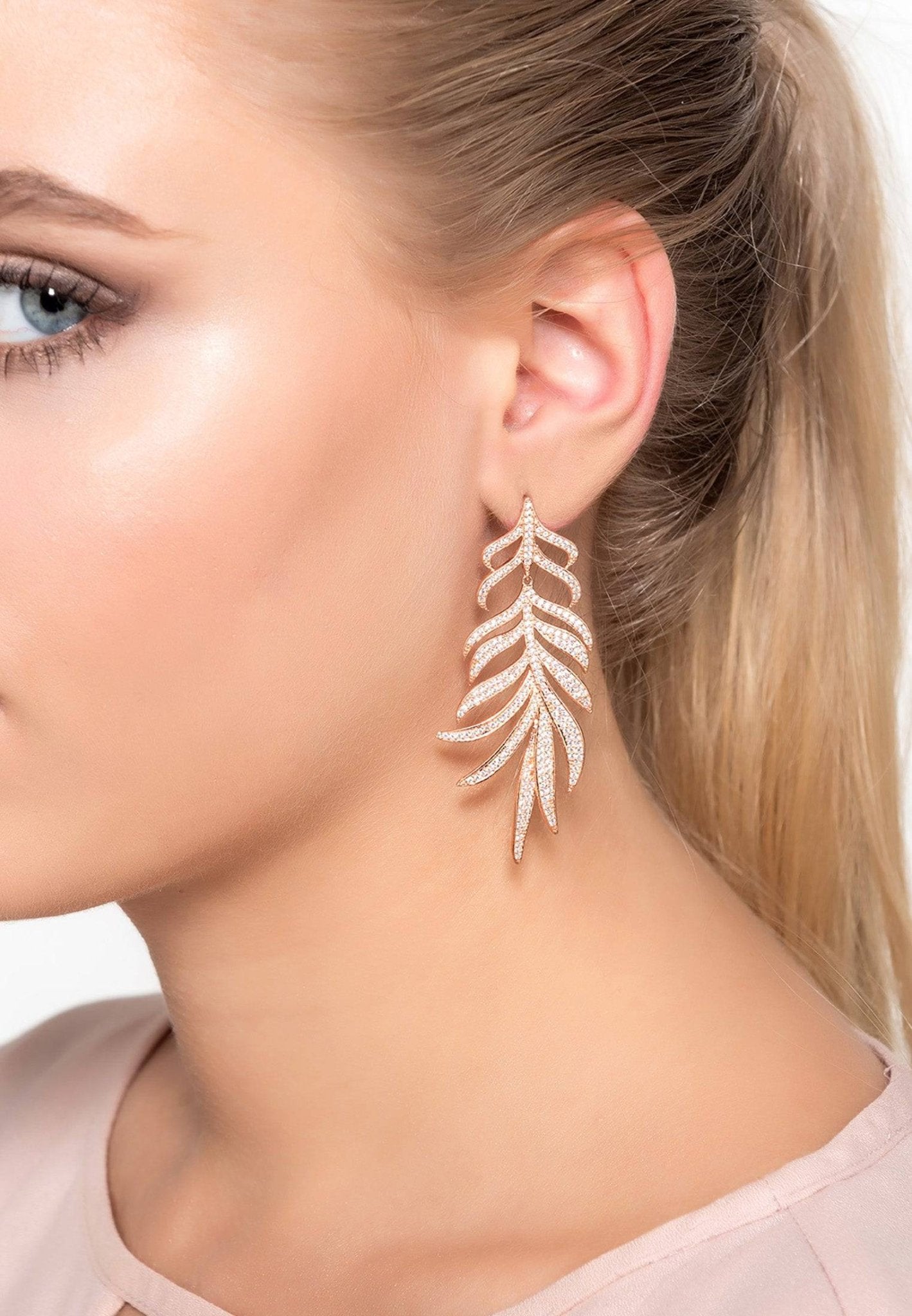 Elegant Feathered Leaf Statement Drop Earrings in silver with sparkling cubic zirconia, showcasing a nature-inspired design.