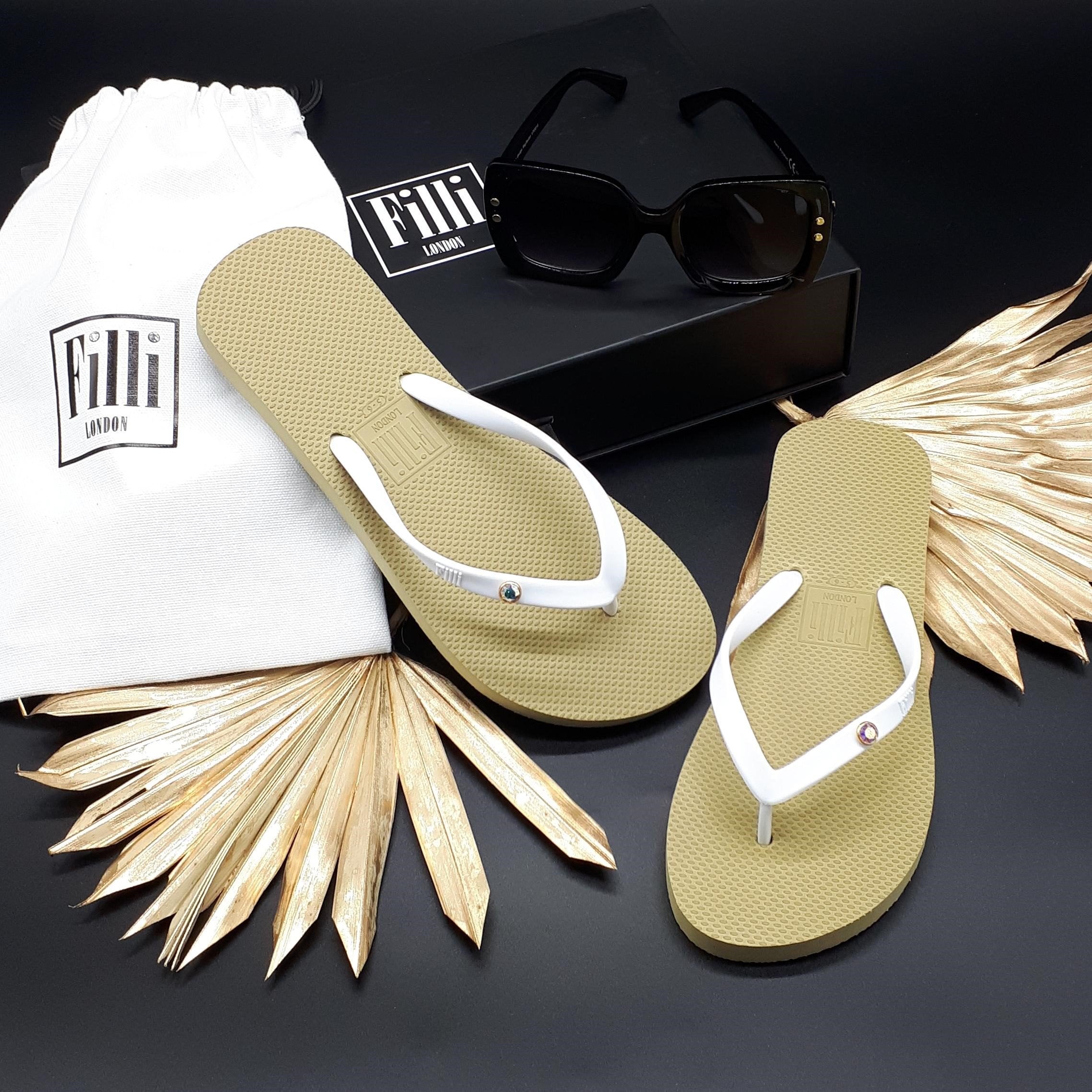 Filli London Aurora Luxury Crystal Flip Flops in White on Gold, featuring Swarovski crystals and a gold plated setting, elegantly displayed.