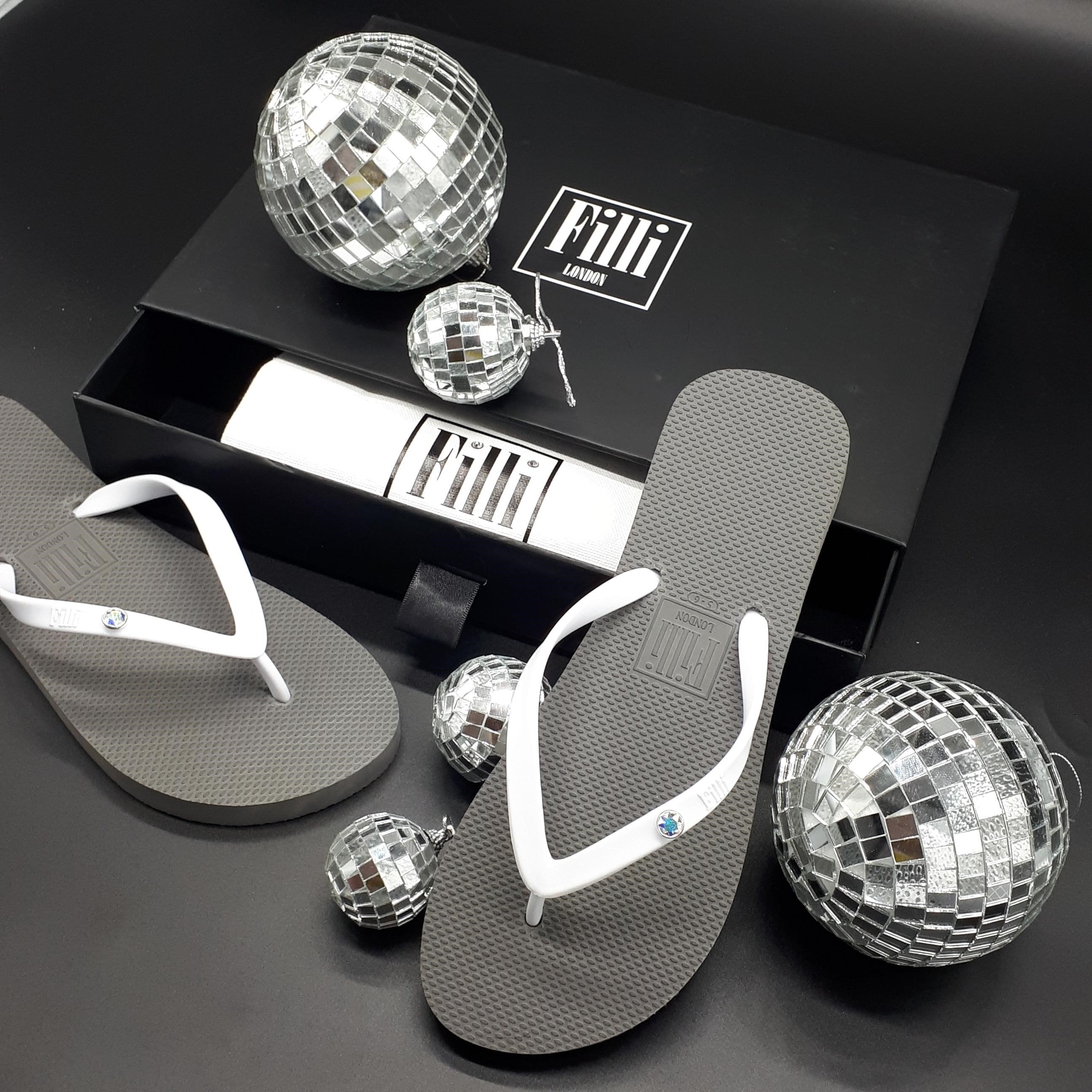 Filli London Aurora Luxury Crystal Flip Flops in White on Silver, featuring Swarovski crystals and a silver plated casing.