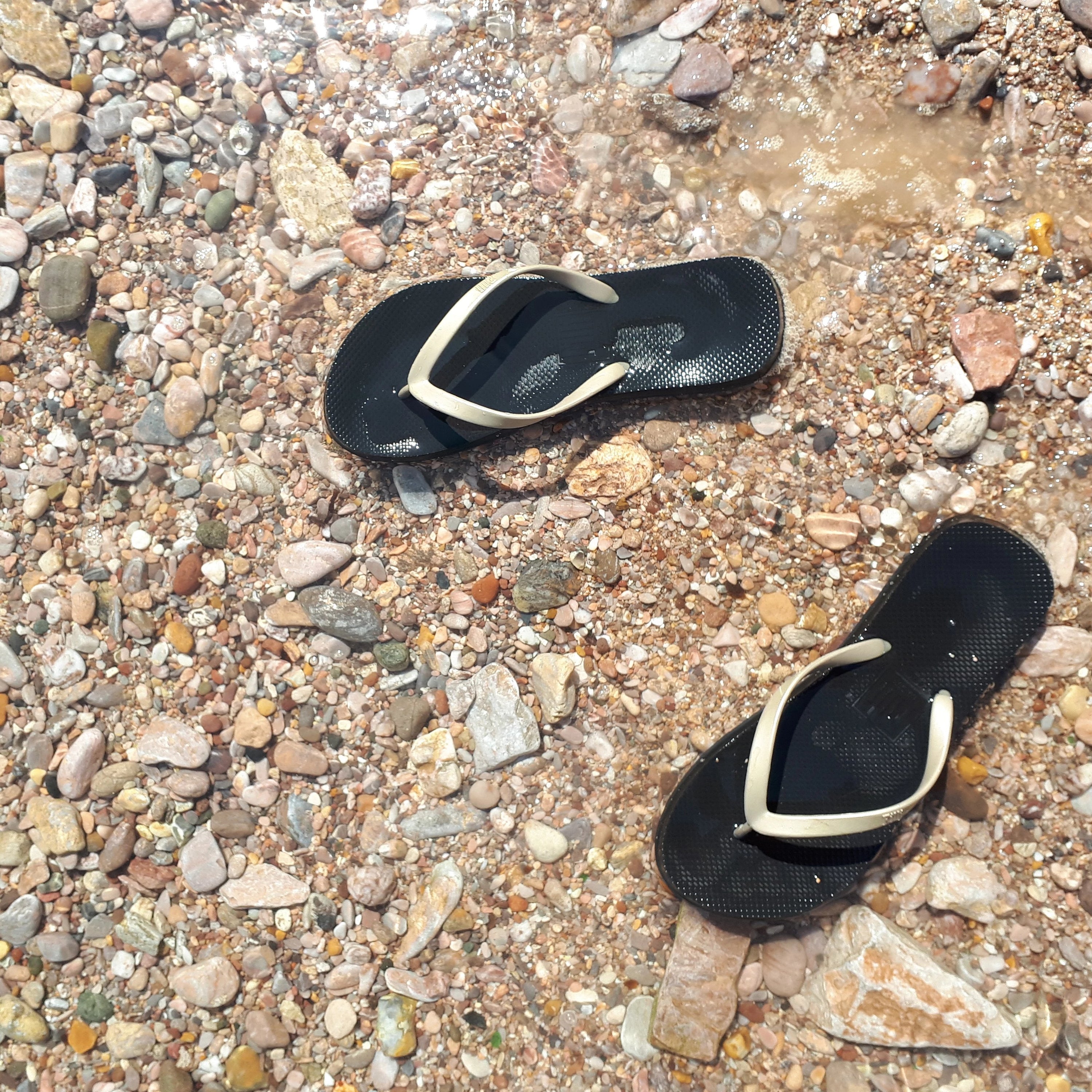 Filli London Naked Flip Flops in Gold on Black with embossed logo and rice pattern footbed.