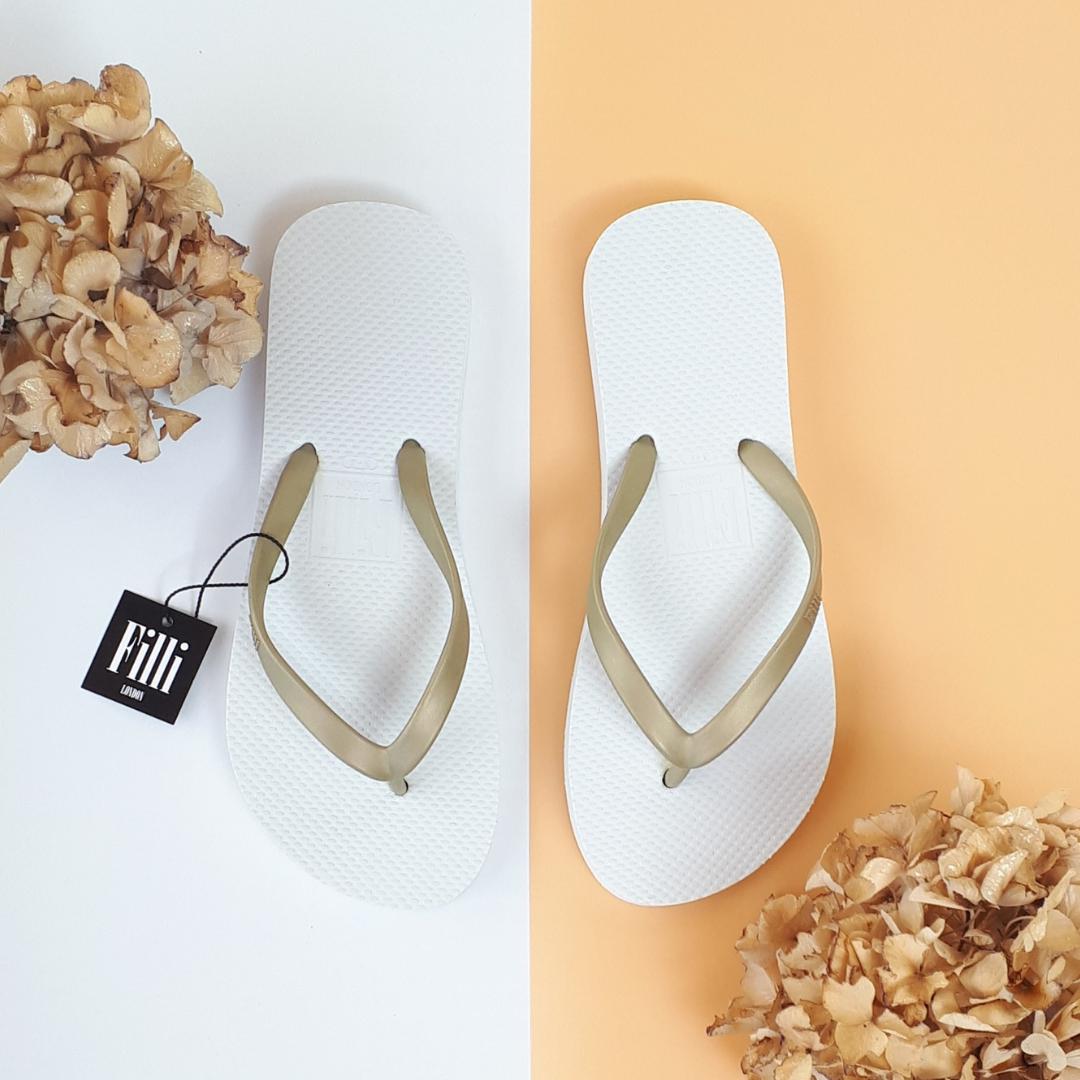 Filli London Naked Flip Flops in Gold on White with embossed logo and rice pattern footbed.