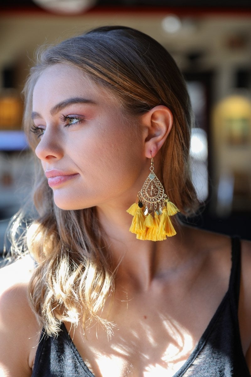 Elegant Filigree Raffia Tassel Earrings featuring intricate brass design and soft tassels, perfect for stylish accessorizing.