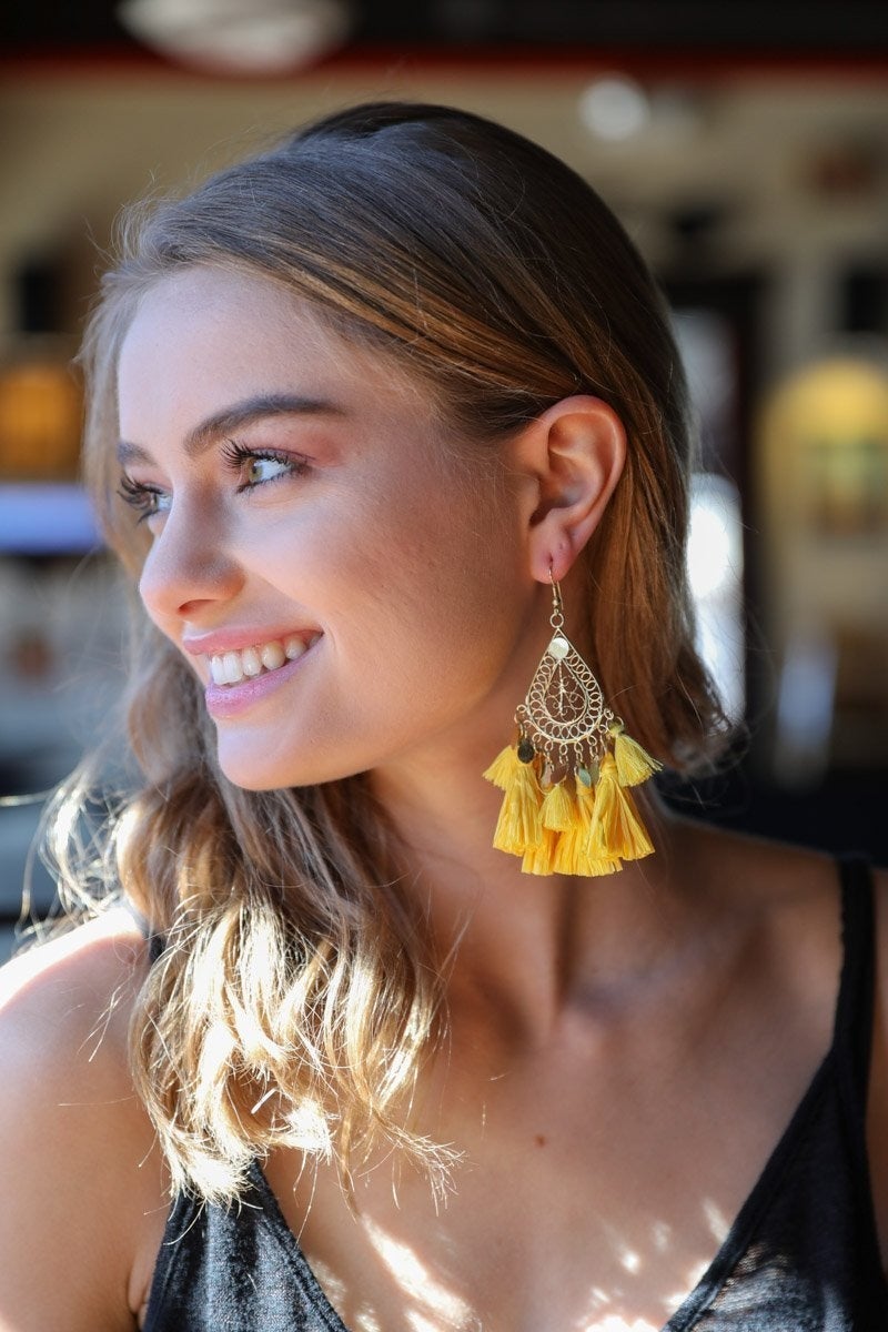 Elegant Filigree Raffia Tassel Earrings featuring intricate brass design and soft tassels, perfect for stylish accessorizing.