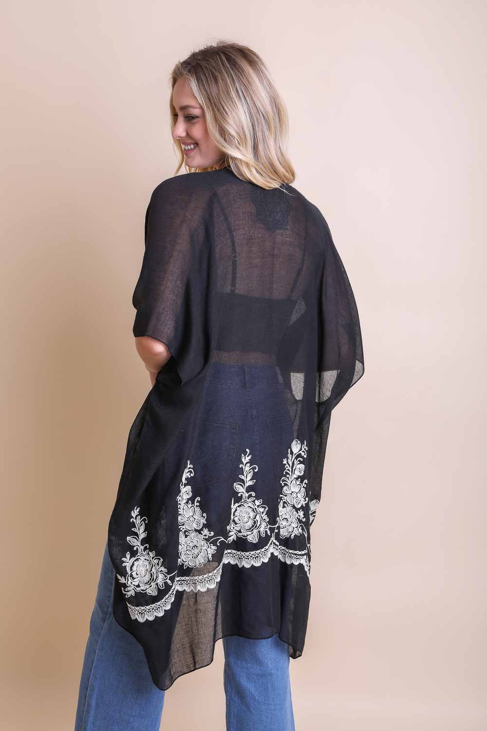 A lightweight floral embroidered stitched kimono, perfect for summer layering, featuring intricate floral designs and a flowing silhouette.