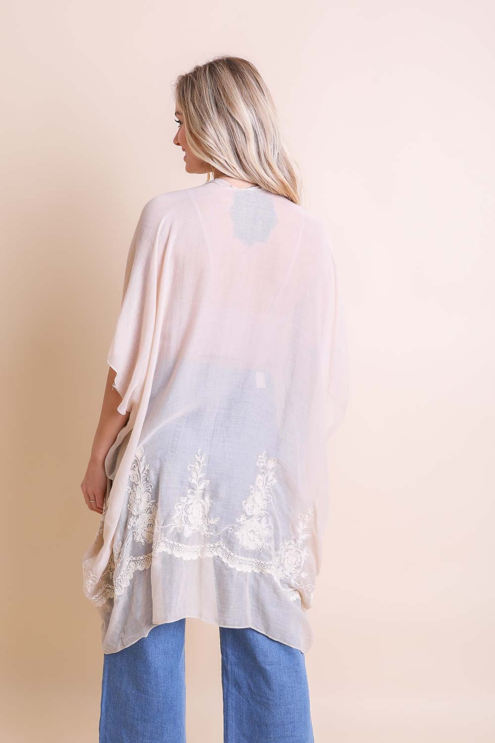 A lightweight floral embroidered stitched kimono, perfect for summer layering, featuring intricate floral designs and a flowing silhouette.