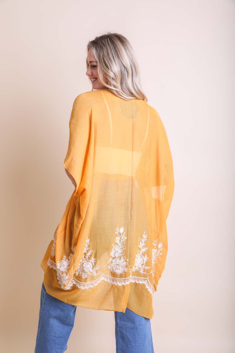 A lightweight floral embroidered stitched kimono, perfect for summer layering, featuring intricate floral designs and a flowing silhouette.