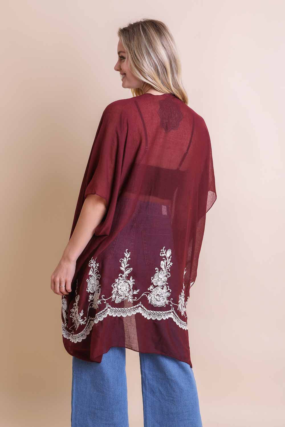 A lightweight floral embroidered stitched kimono, perfect for summer layering, featuring intricate floral designs and a flowing silhouette.