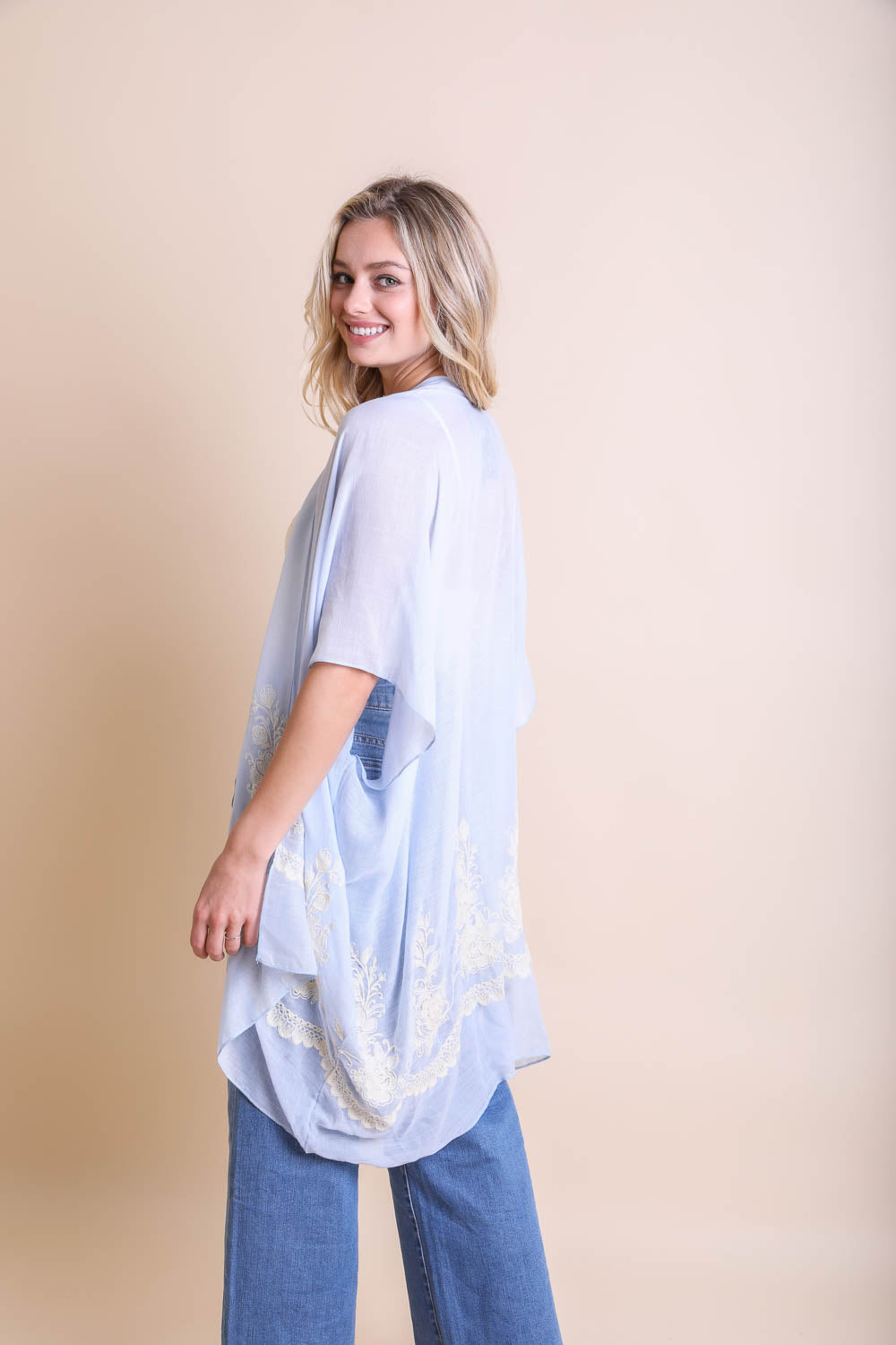 A lightweight floral embroidered stitched kimono, perfect for summer layering, featuring intricate floral designs and a flowing silhouette.