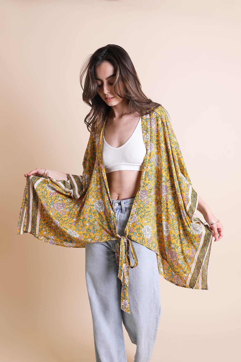 A lightweight floral front tie kimono wrap, perfect for summer outings, featuring vibrant colors and a flattering design.