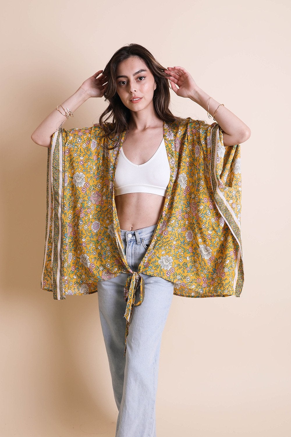 A lightweight floral front tie kimono wrap, perfect for summer outings, featuring vibrant colors and a flattering design.