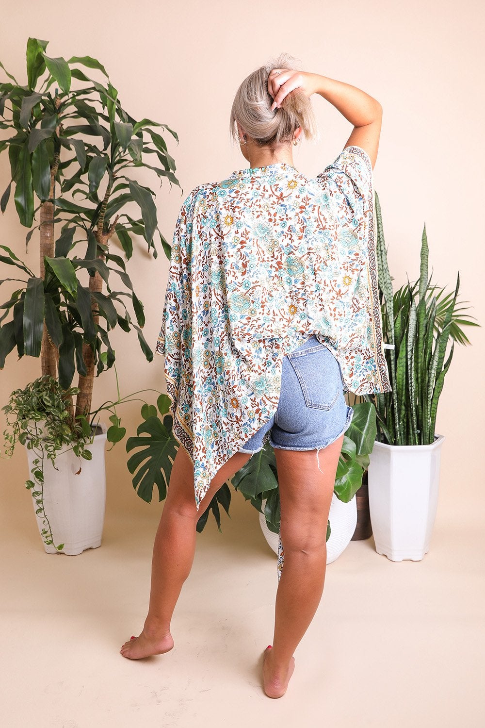 A lightweight floral front tie kimono wrap, perfect for summer outings, featuring vibrant colors and a flattering design.