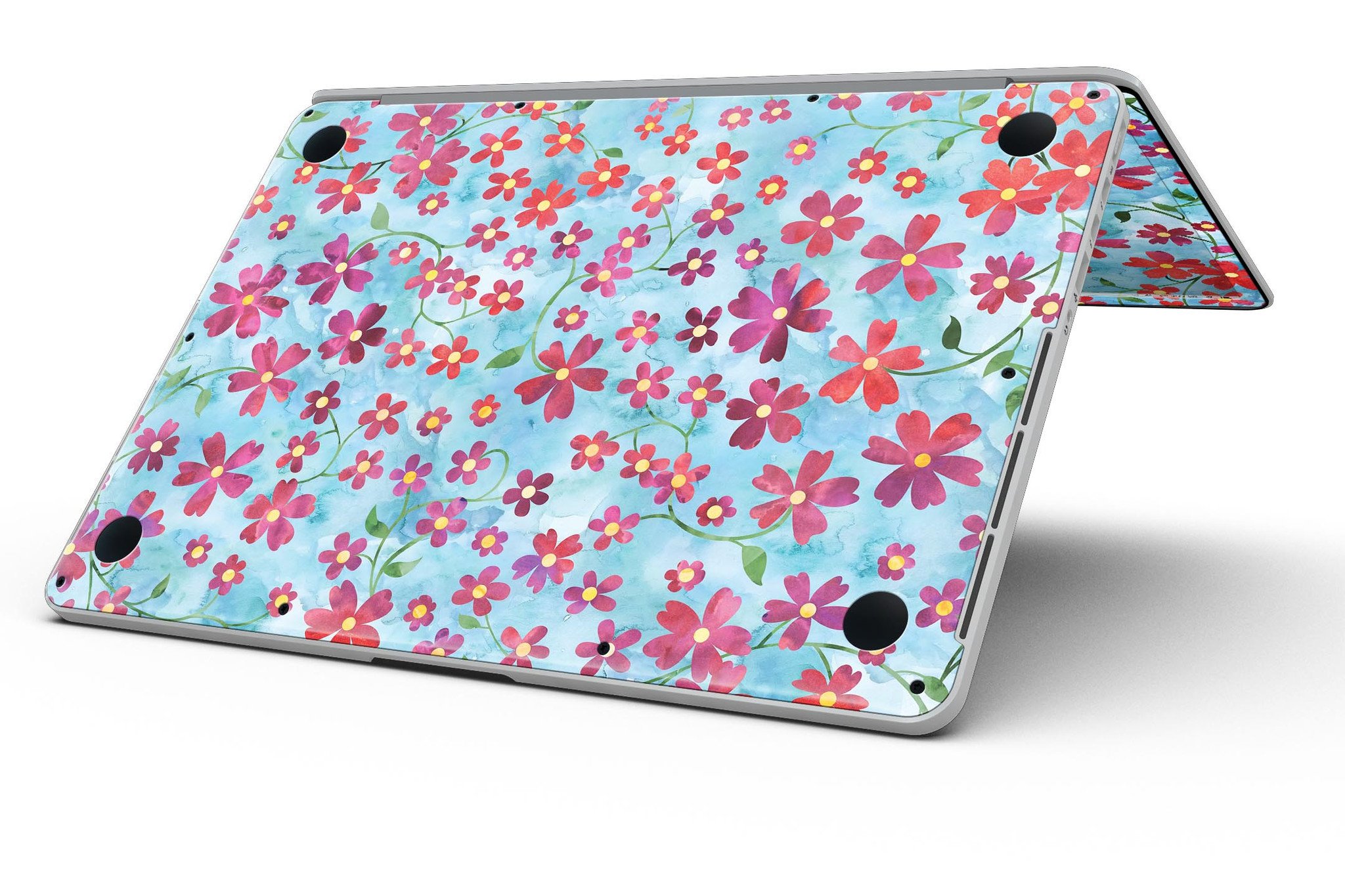 A MacBook Pro with a floral skin featuring stems over a light blue watercolor background, showcasing elegance and style.