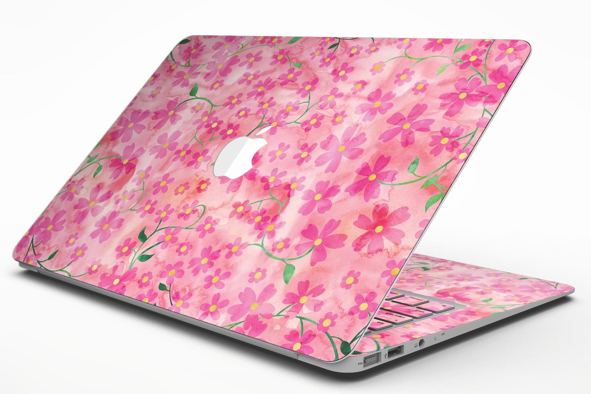 A MacBook Air adorned with a floral skin featuring stems over a pink watercolor background, showcasing vibrant colors and a stylish design.