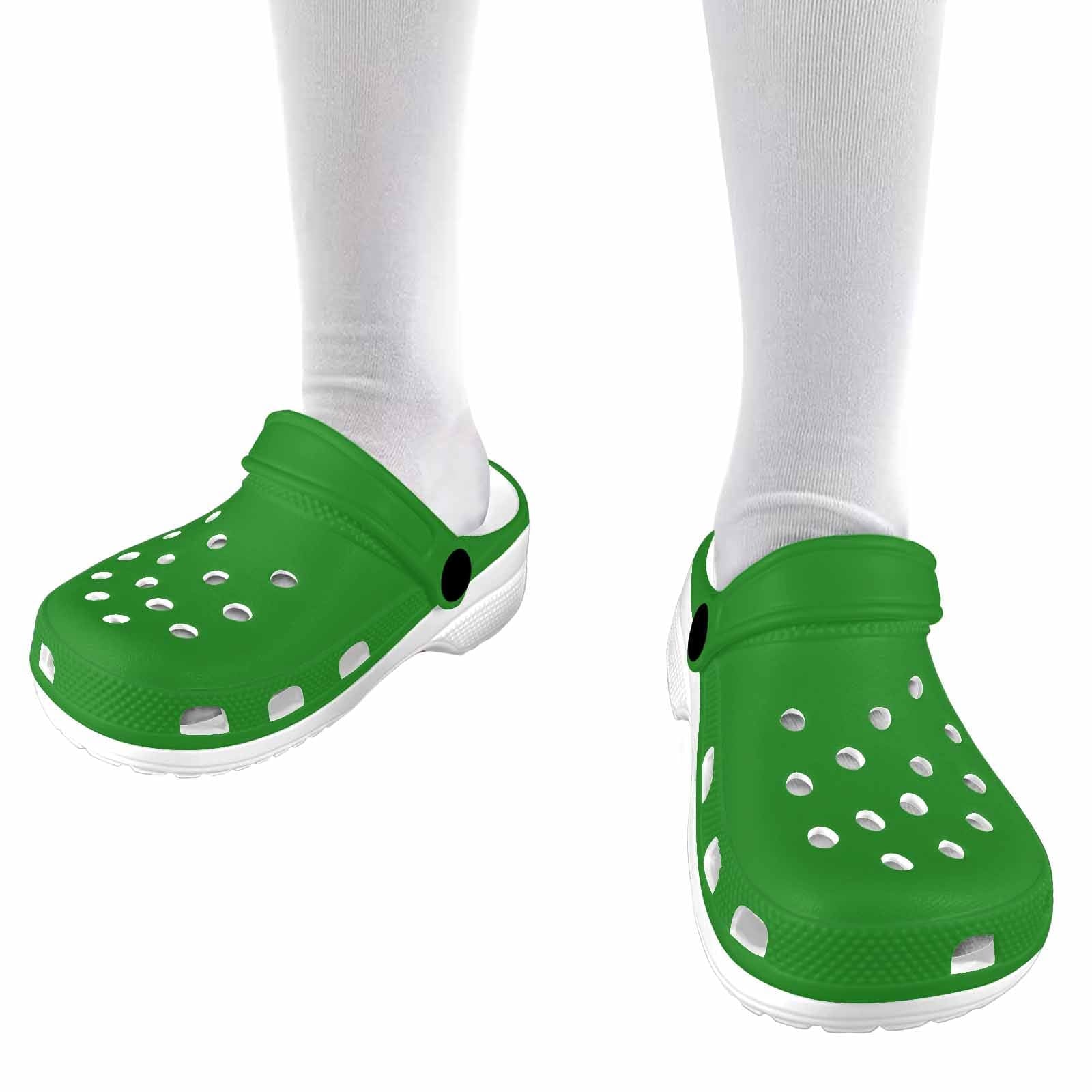 A pair of forest green clogs designed for youth, featuring a slip-on design, ventilation ports, and cushioned soles for comfort.