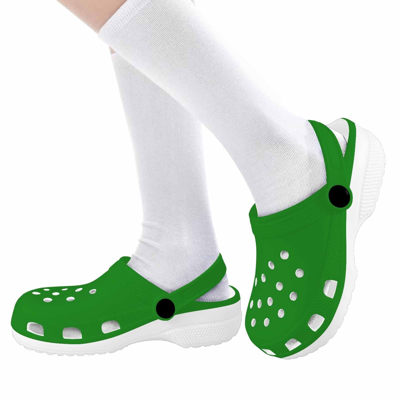 A pair of forest green clogs designed for youth, featuring a slip-on design, ventilation ports, and cushioned soles for comfort.