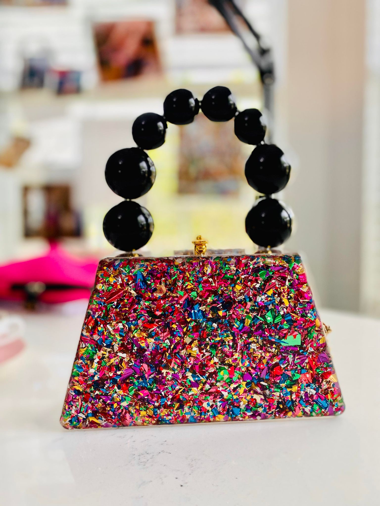 Forever Love confettie Top Handle Acrylic Clutch featuring a vintage design with colorful crystals and an engraved pattern.