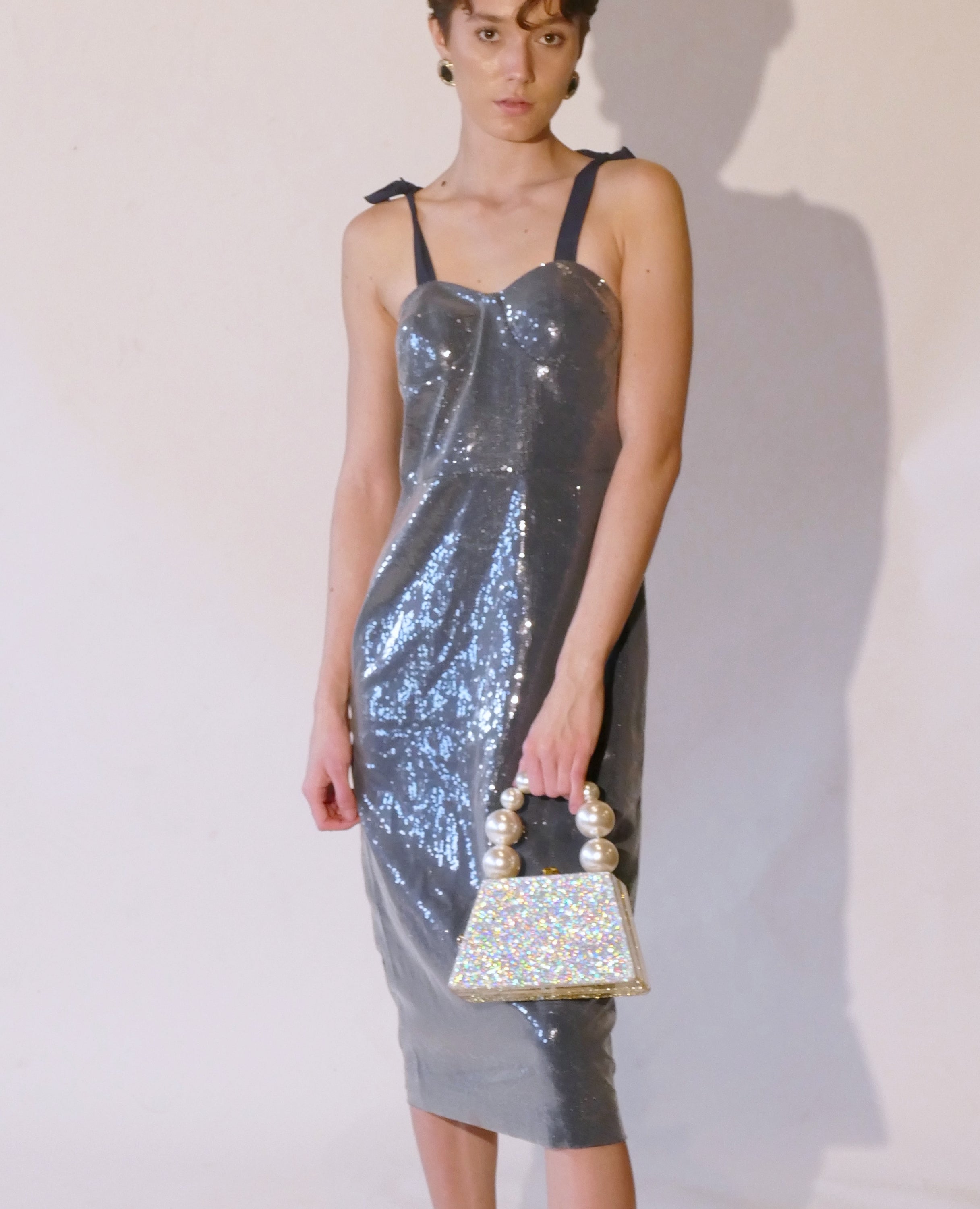 Forever Love Glitter Top Handle Acrylic Clutch featuring a two-tone gold and silver design with a pearl top handle.