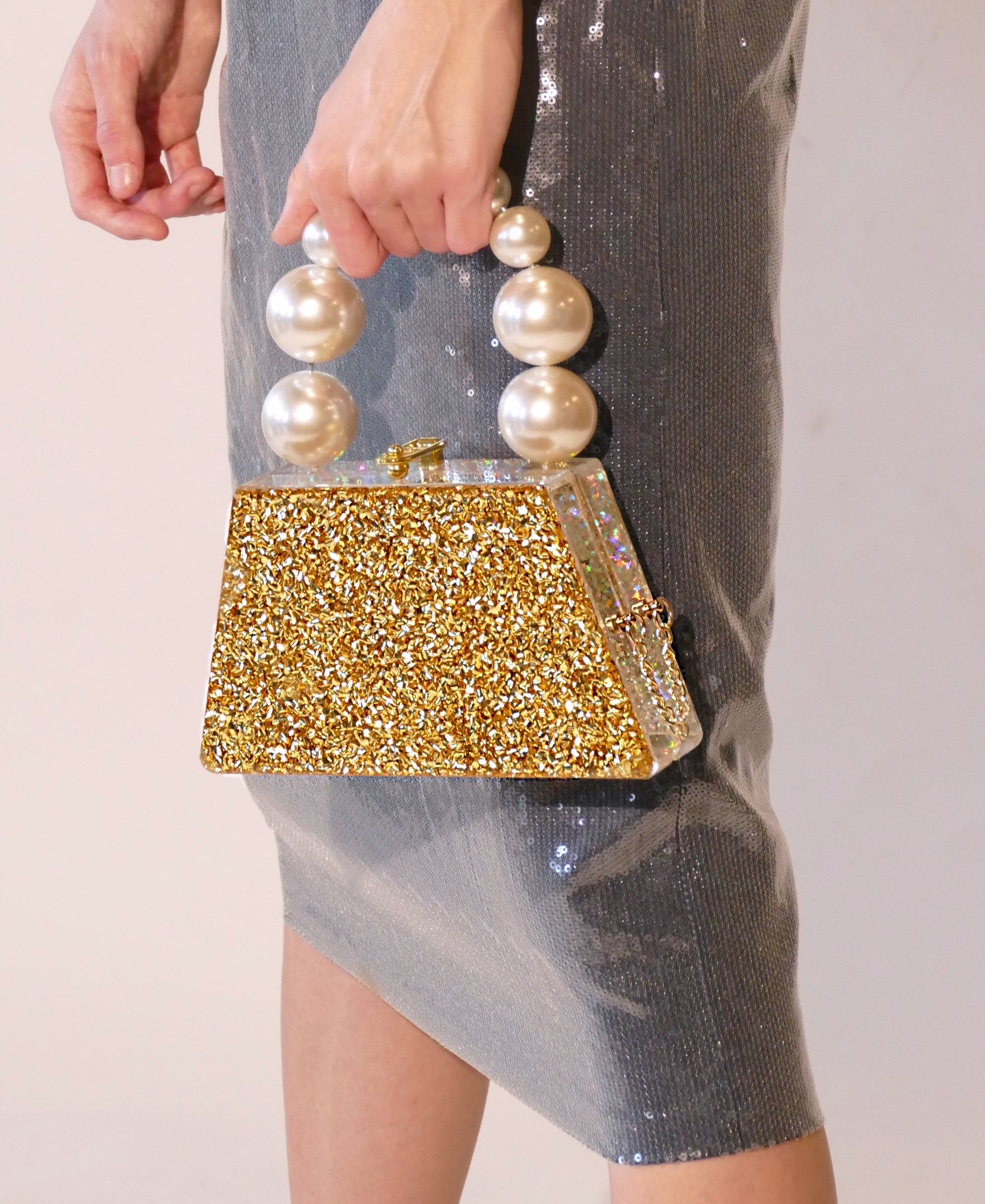 Forever Love Glitter Top Handle Acrylic Clutch featuring a two-tone gold and silver design with a pearl top handle.