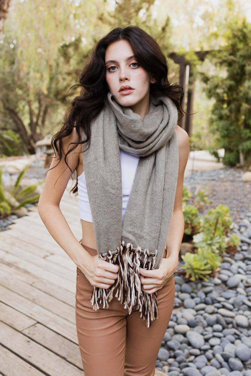 A stylish Frayed Bohemian Flow Scarf with frayed edges, showcasing a soft and lightweight fabric, perfect for chilly days.