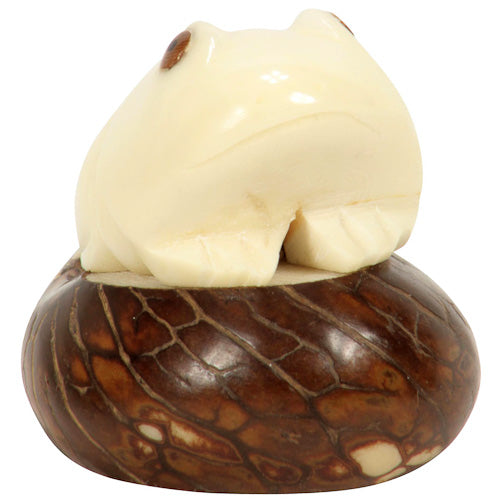 Hand-carved Frog Figurine made from tagua nuts, showcasing natural colors and intricate details, symbolizing eco-friendly craftsmanship.