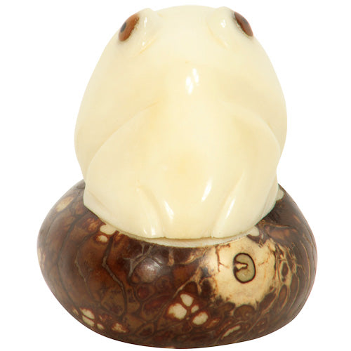 Hand-carved Frog Figurine made from tagua nuts, showcasing natural colors and intricate details, symbolizing eco-friendly craftsmanship.