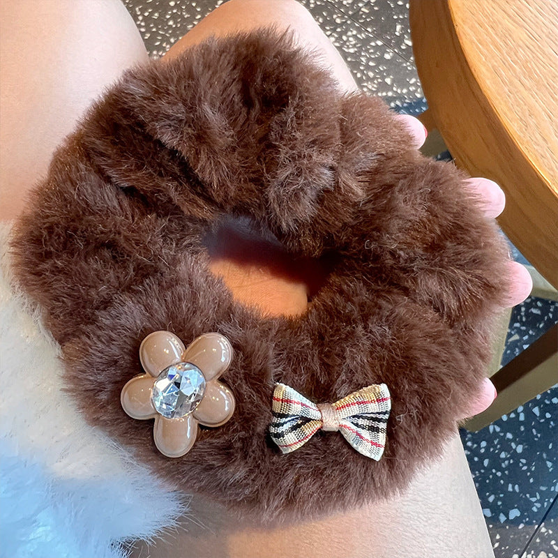 A set of four Fuzzy Bear scrunchies in soft, colorful fabric, perfect for stylish hair accessories.