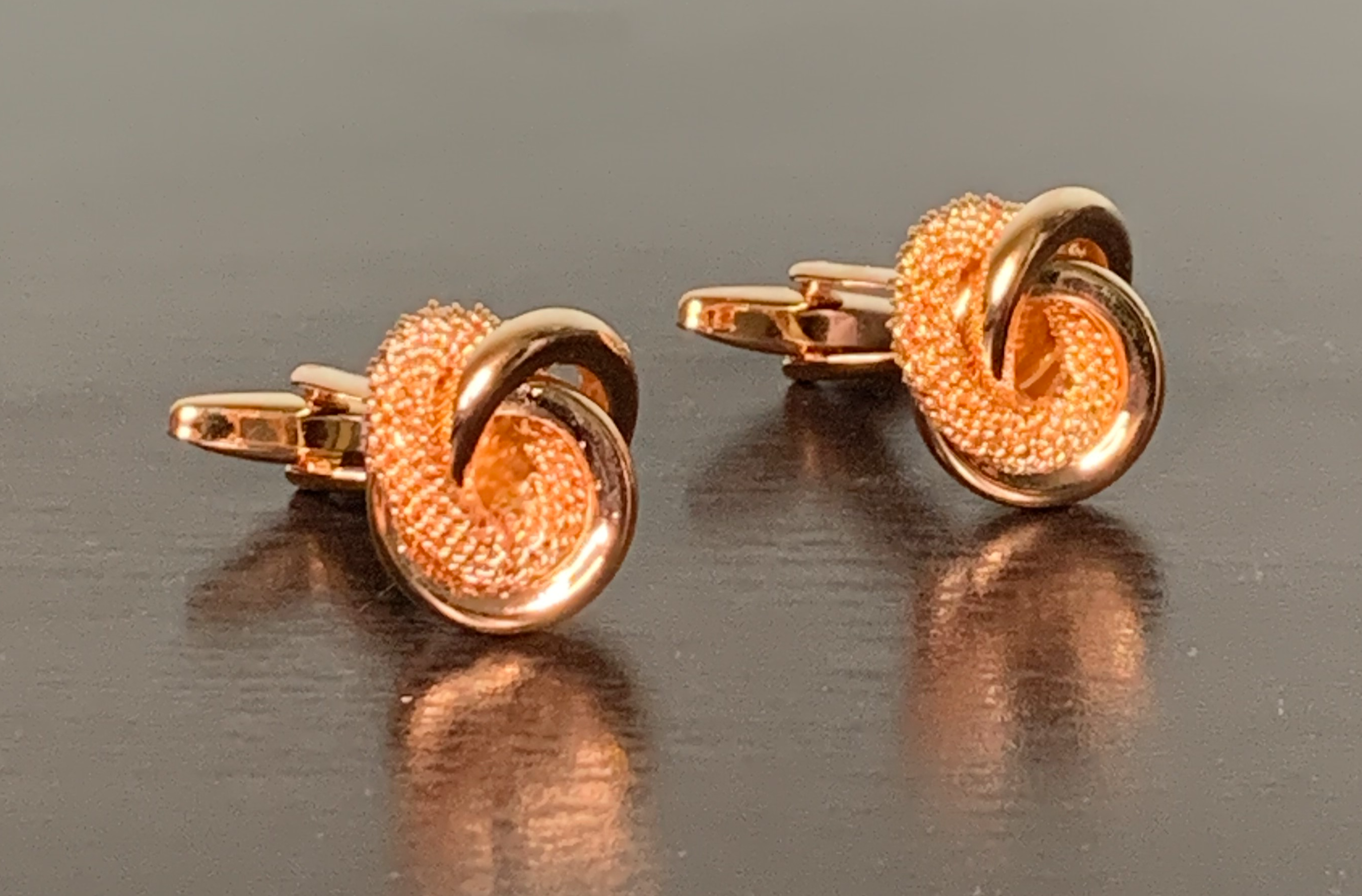 Elegant rose gold cufflinks featuring a unique knot design, symbolizing integrity and commitment.